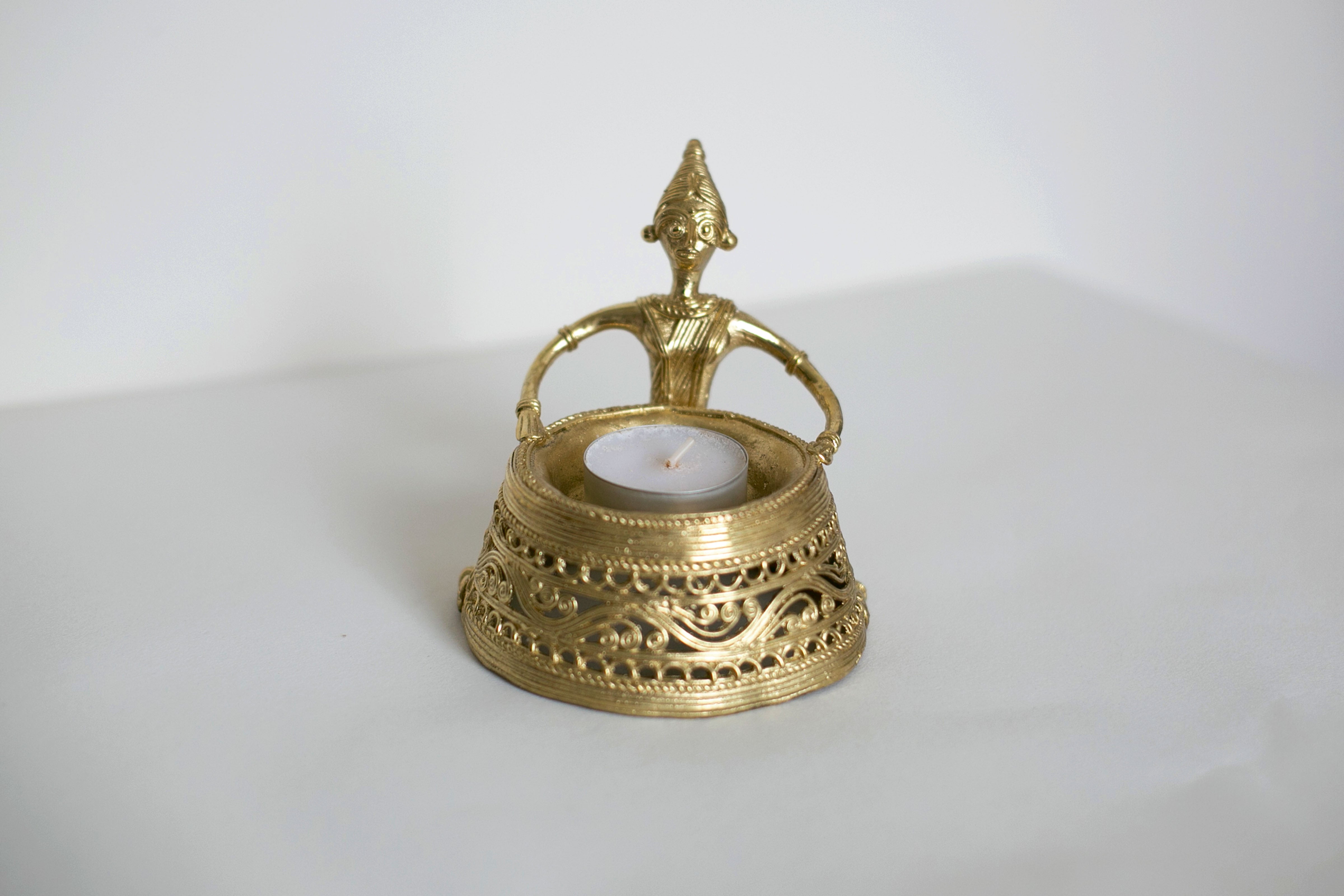 Golden decorative candle holder with intricate design