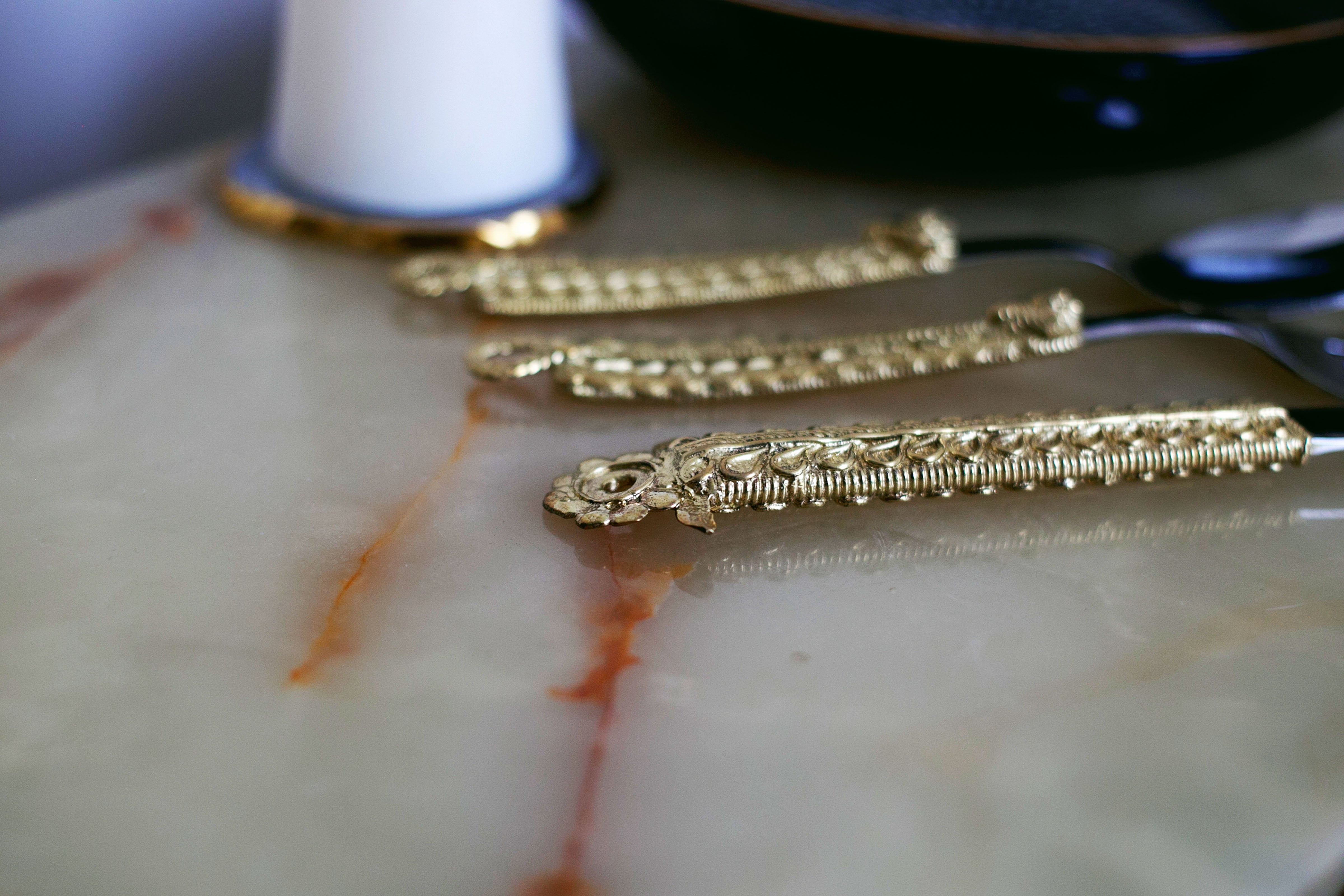 Vintage style gold flatware with intricate detailing