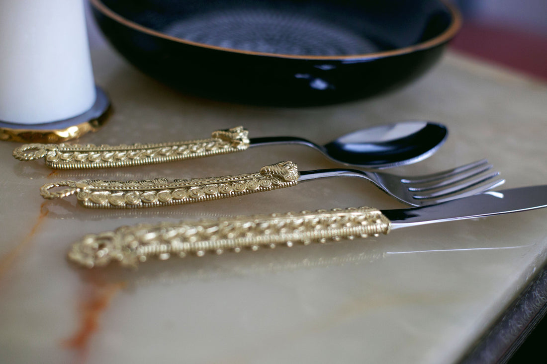 Elegant table setting with decorative brass cutlery