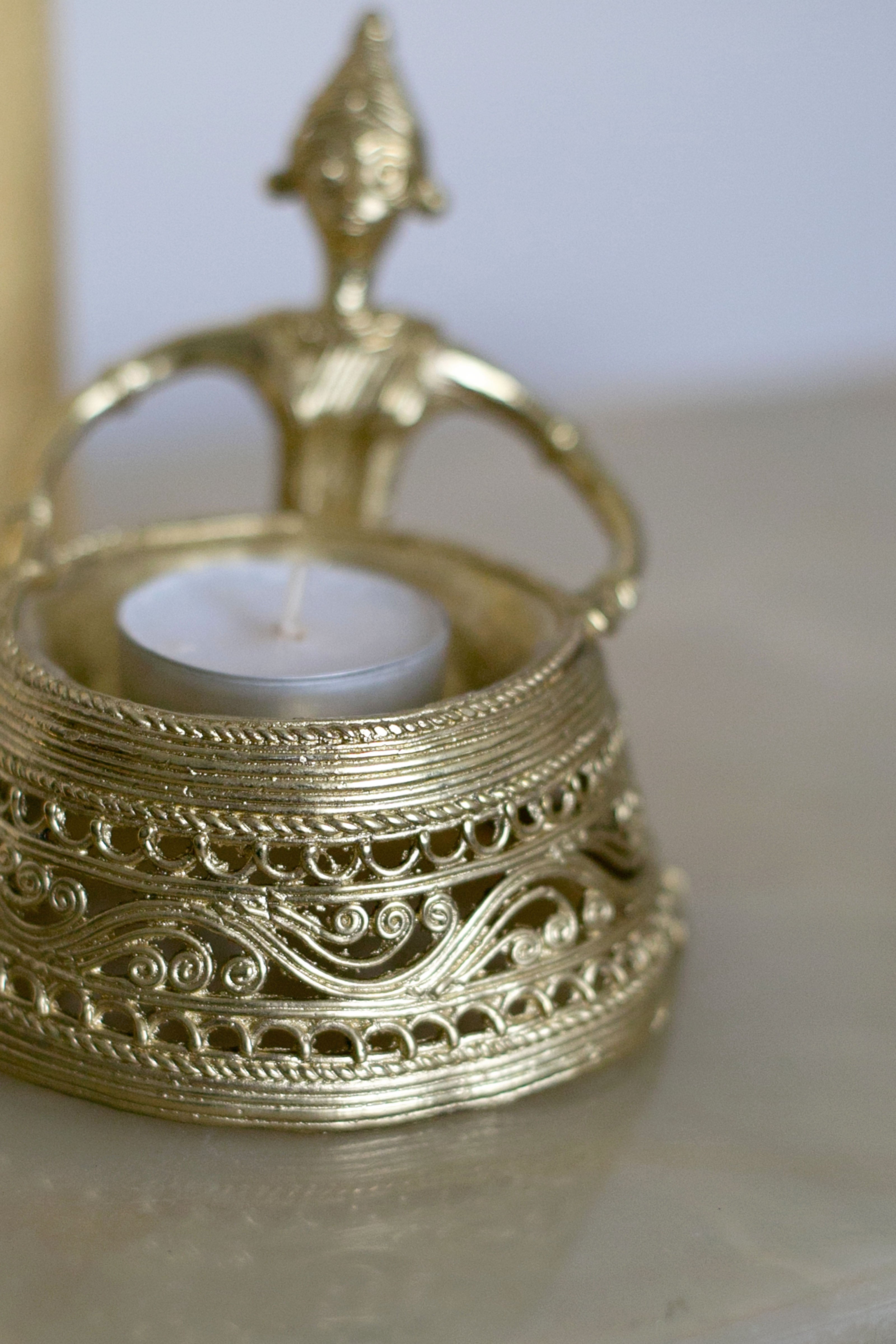 Handcrafted golden candle holder with sculpted top