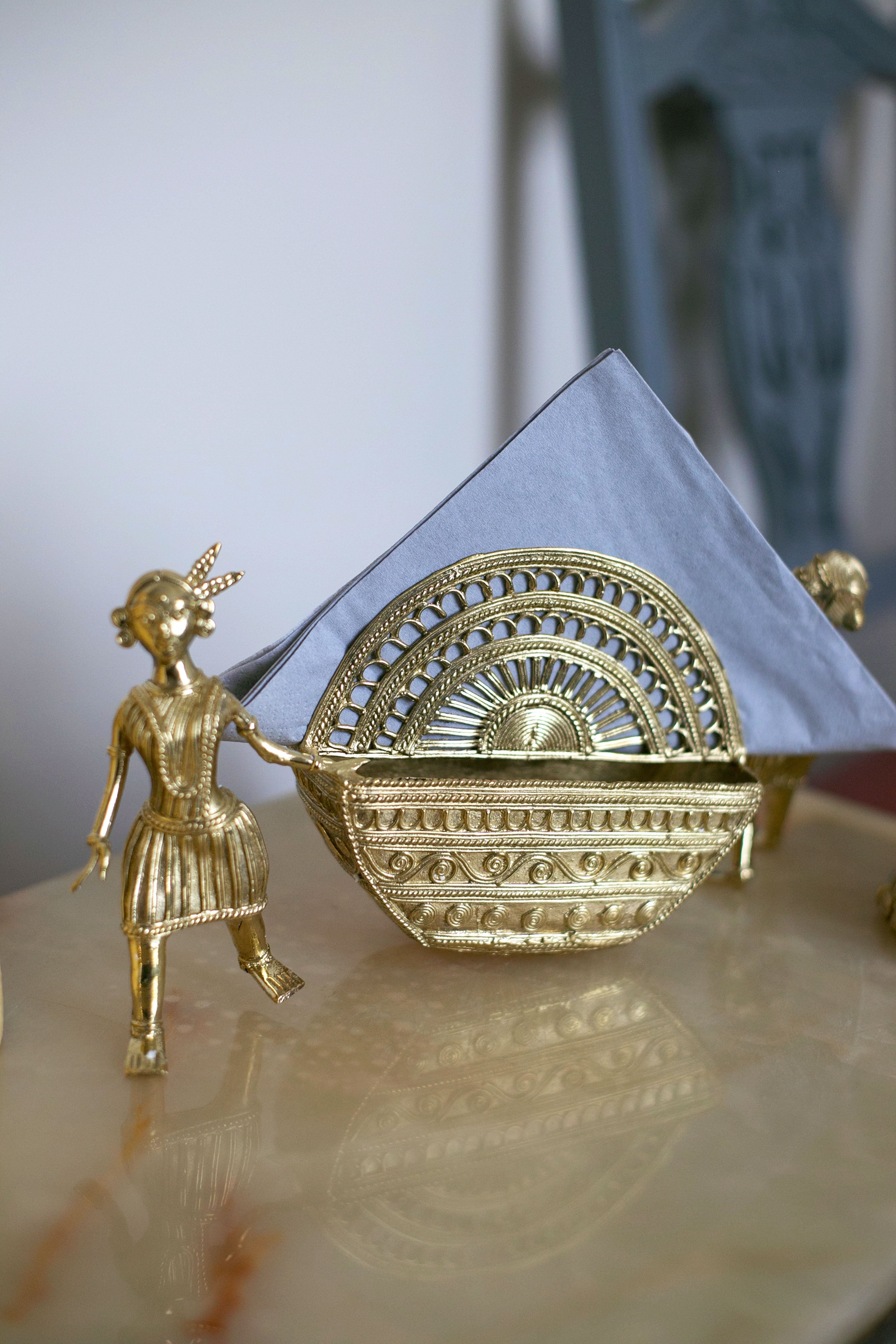 Vintage-style metal sculpture of a girl with basket