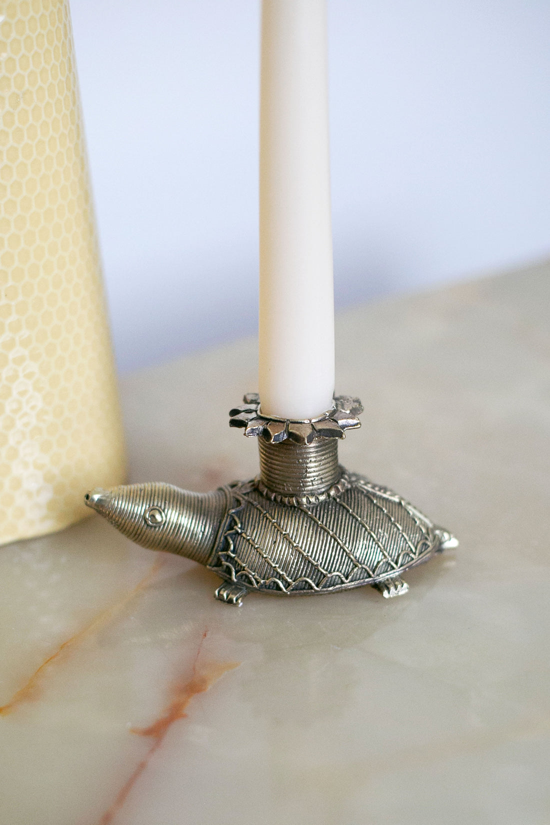 Antique-inspired turtle candlestick with textured shell design