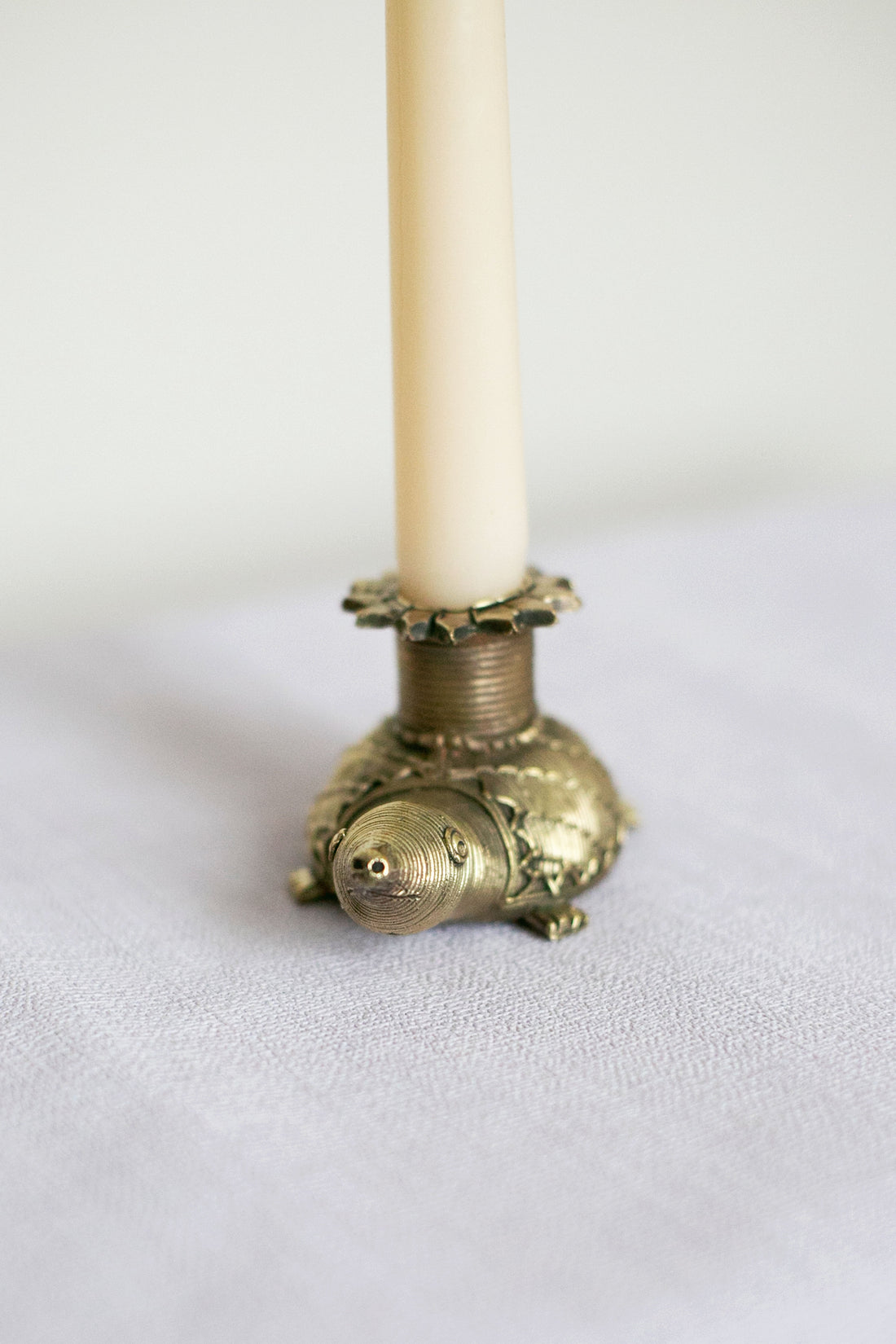 Vintage-style turtle candle holder with cream candle