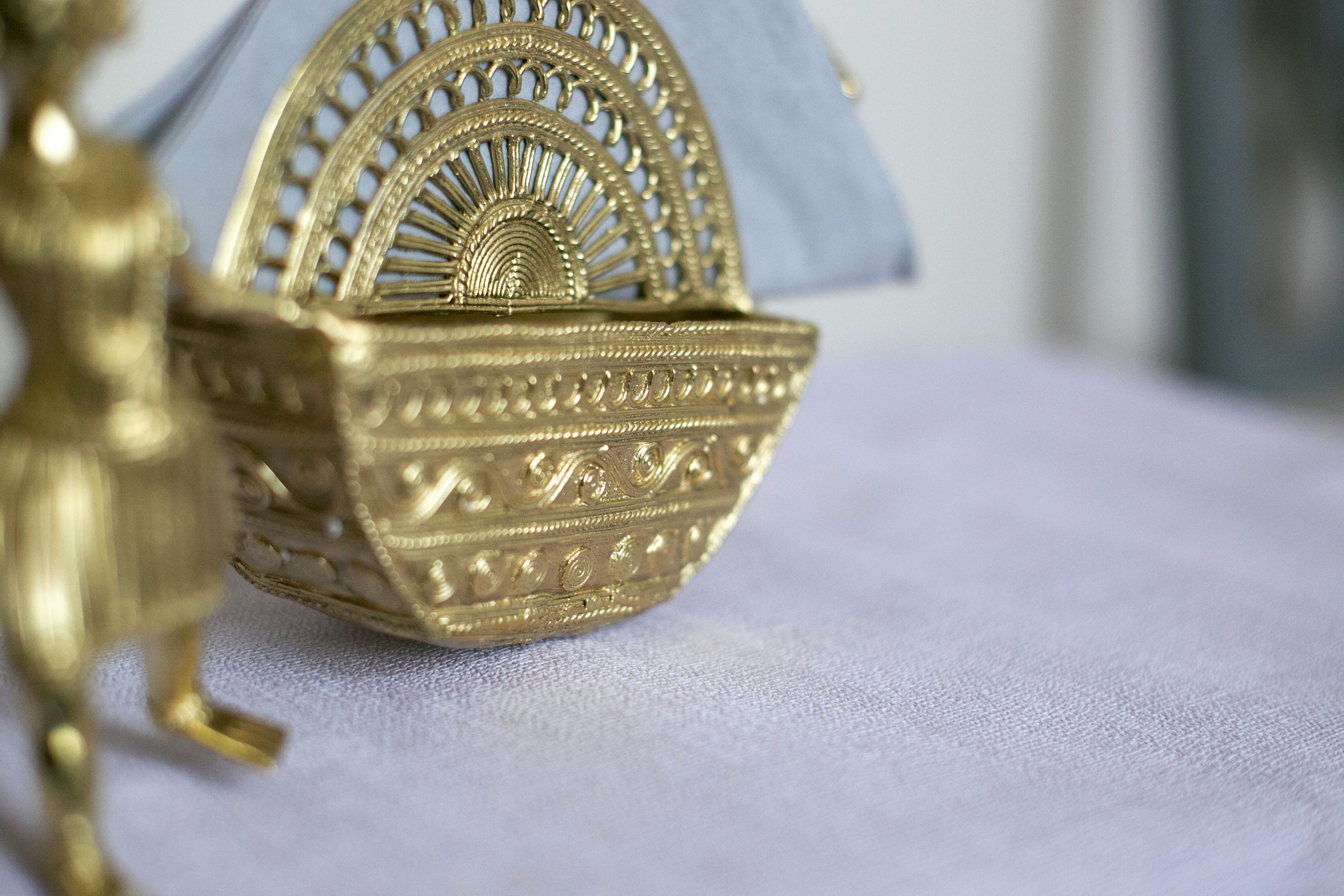 Ornate gold decorative basket with intricate detailing