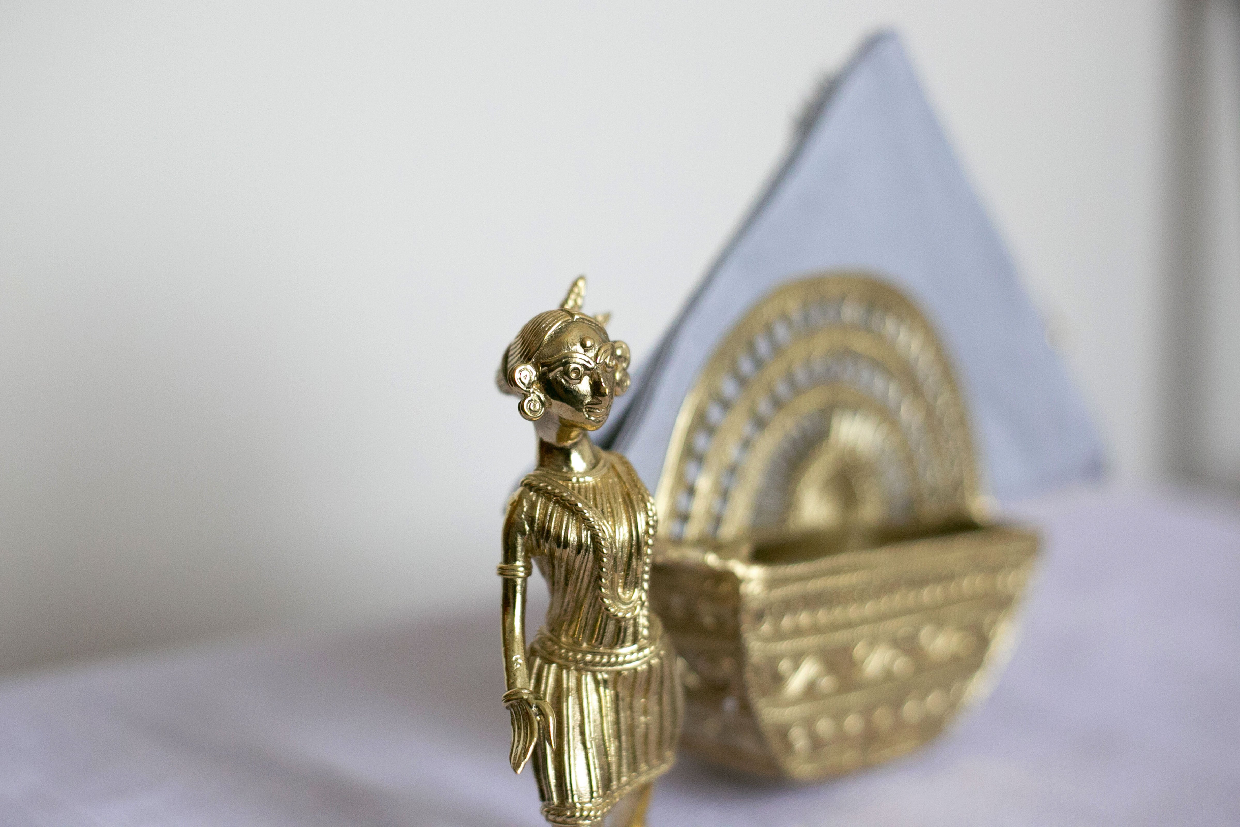 Vintage-inspired metal basket with ornate carvings