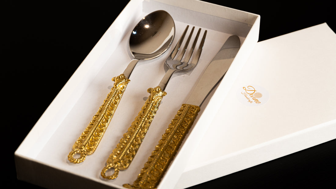 Spoon, fork, and knife set with gold decorative handles in a box