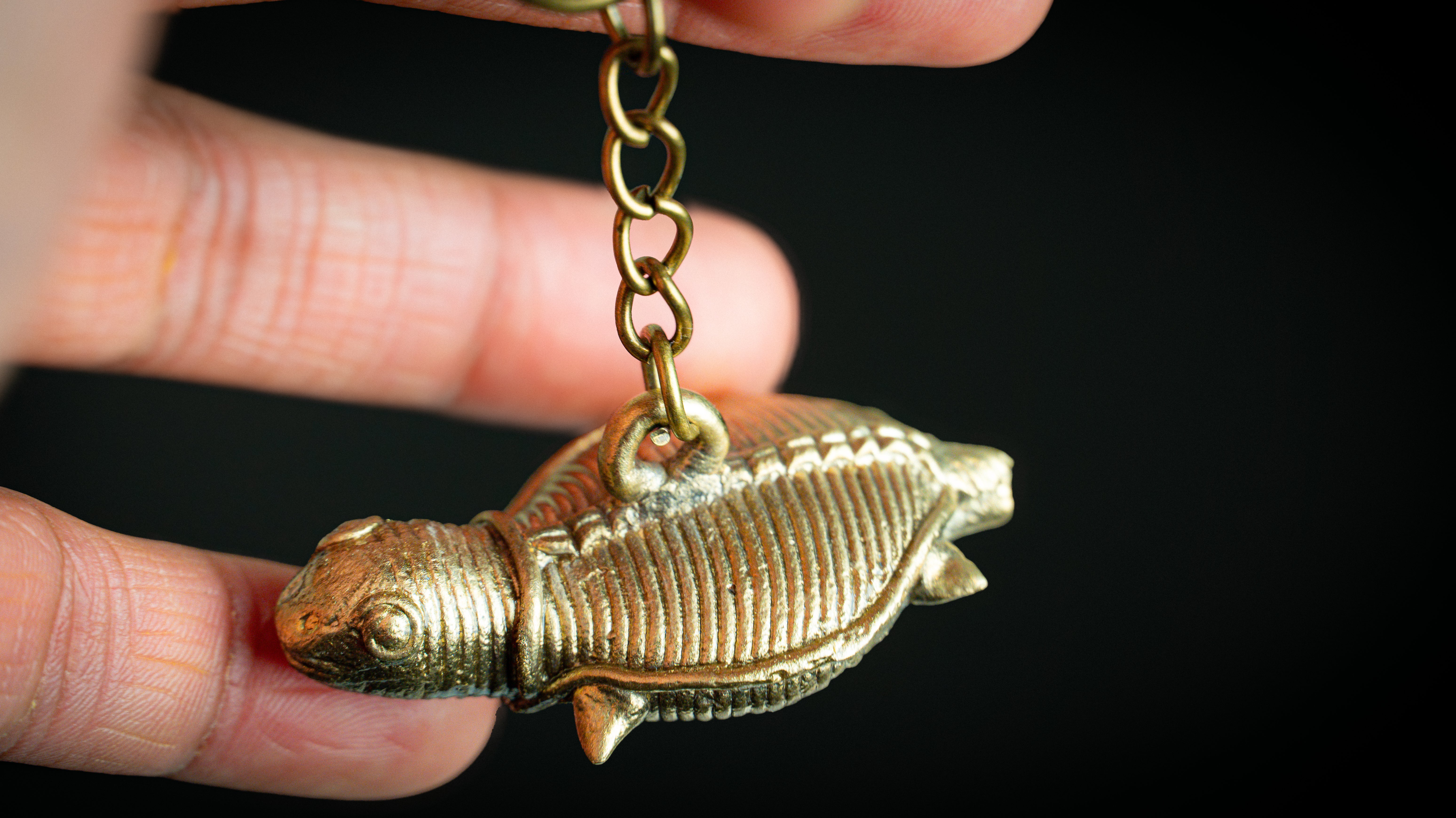 Bronze trilobite fossil keychain with detailed ridges