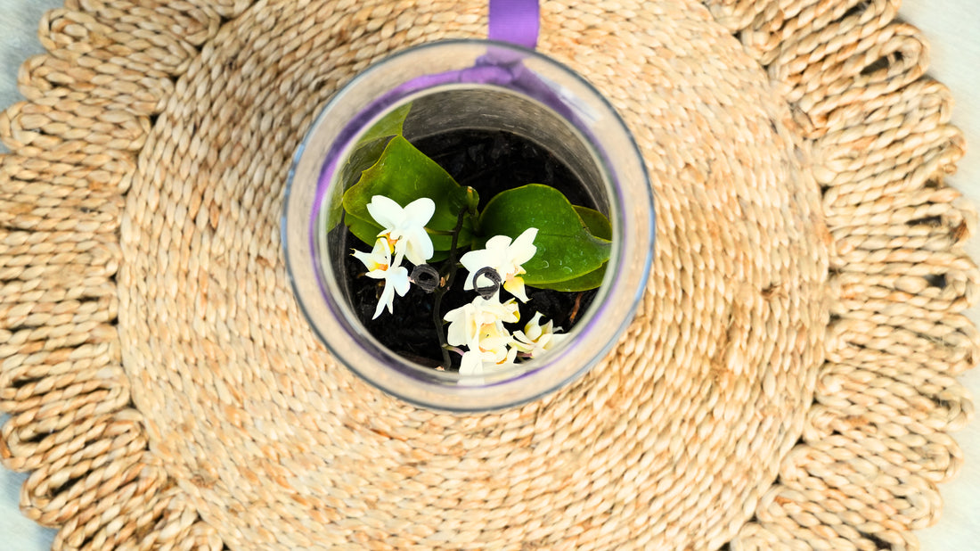 Glass with flowers on a woven mat