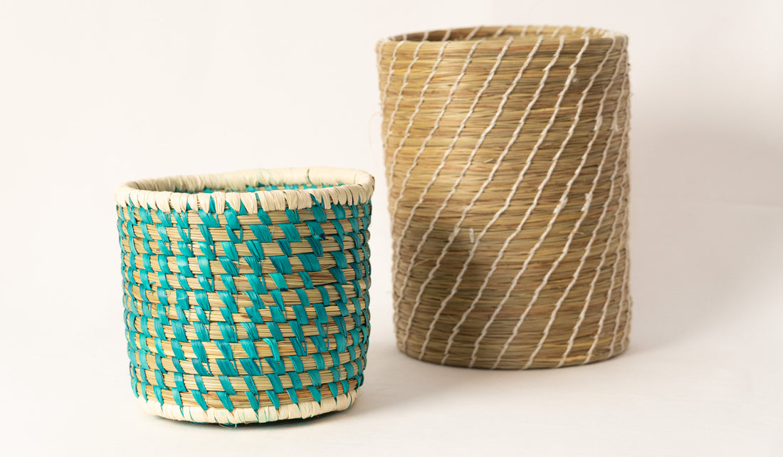 Two woven baskets, one with a blue and green pattern and the other with a natural color, on a white background.