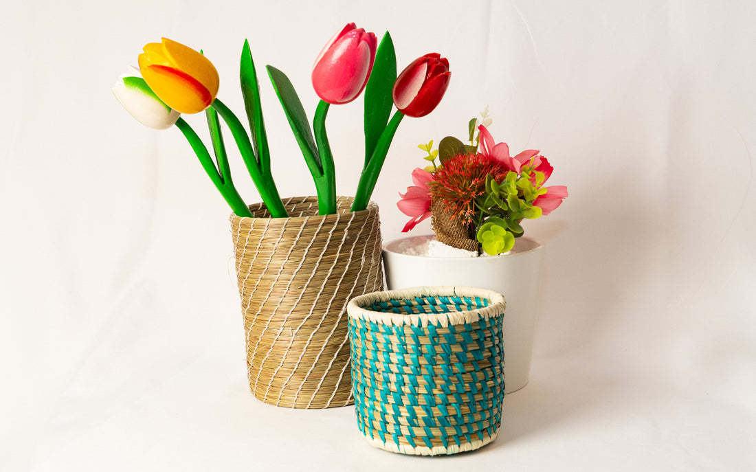 Woven baskets with artificial flowers on a white background