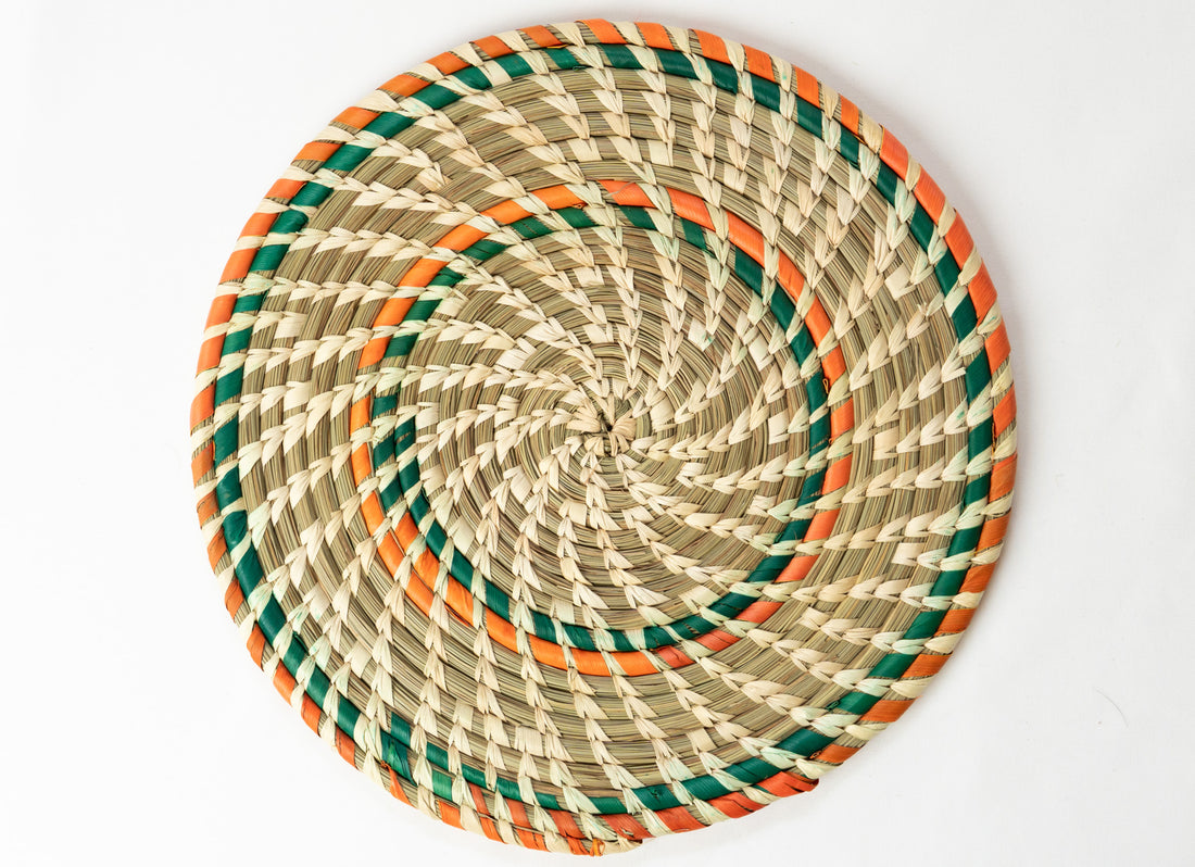 Woven placemat with green and orange accents on a white background