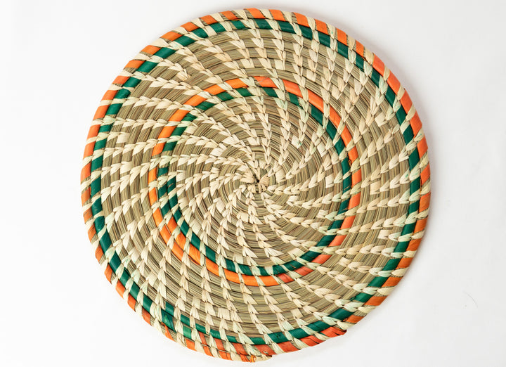 Woven placemat with green and orange accents on a white background