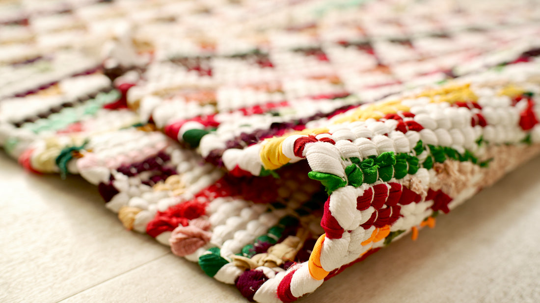 Colorful braided rug on a light wooden floor