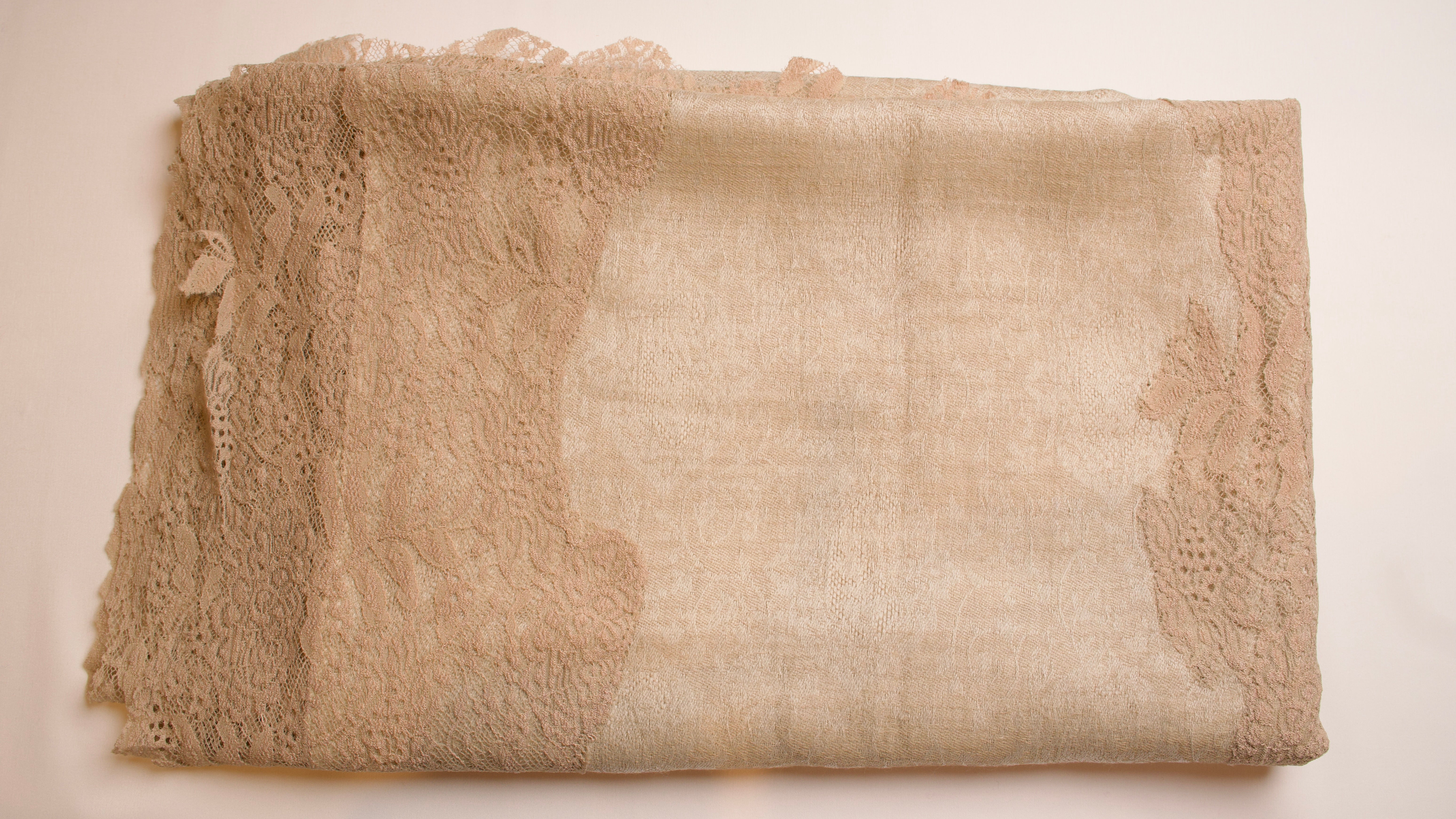 Beige fabric with lace trim on a beige background