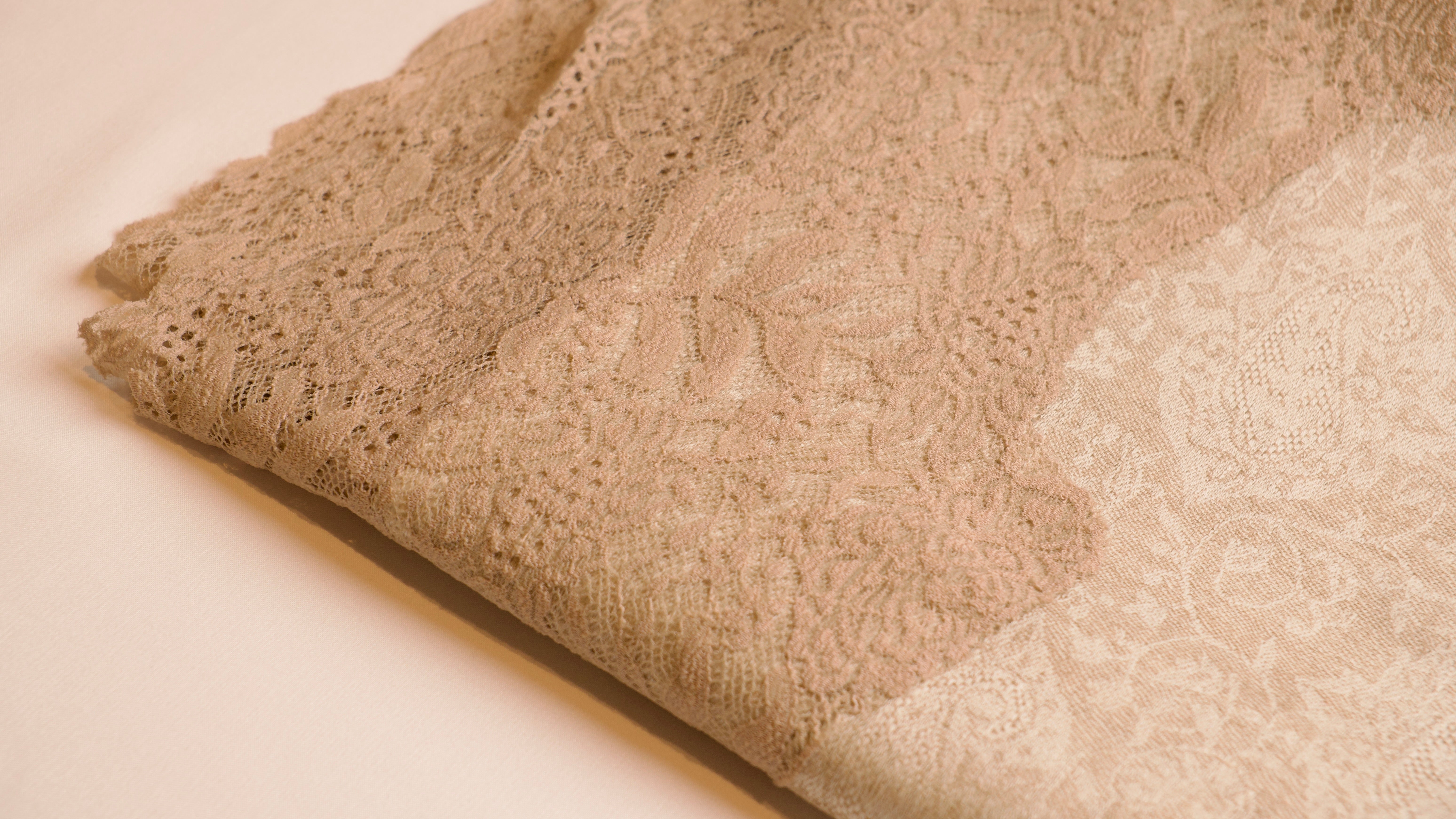 Close-up of textured beige fabric on a light background