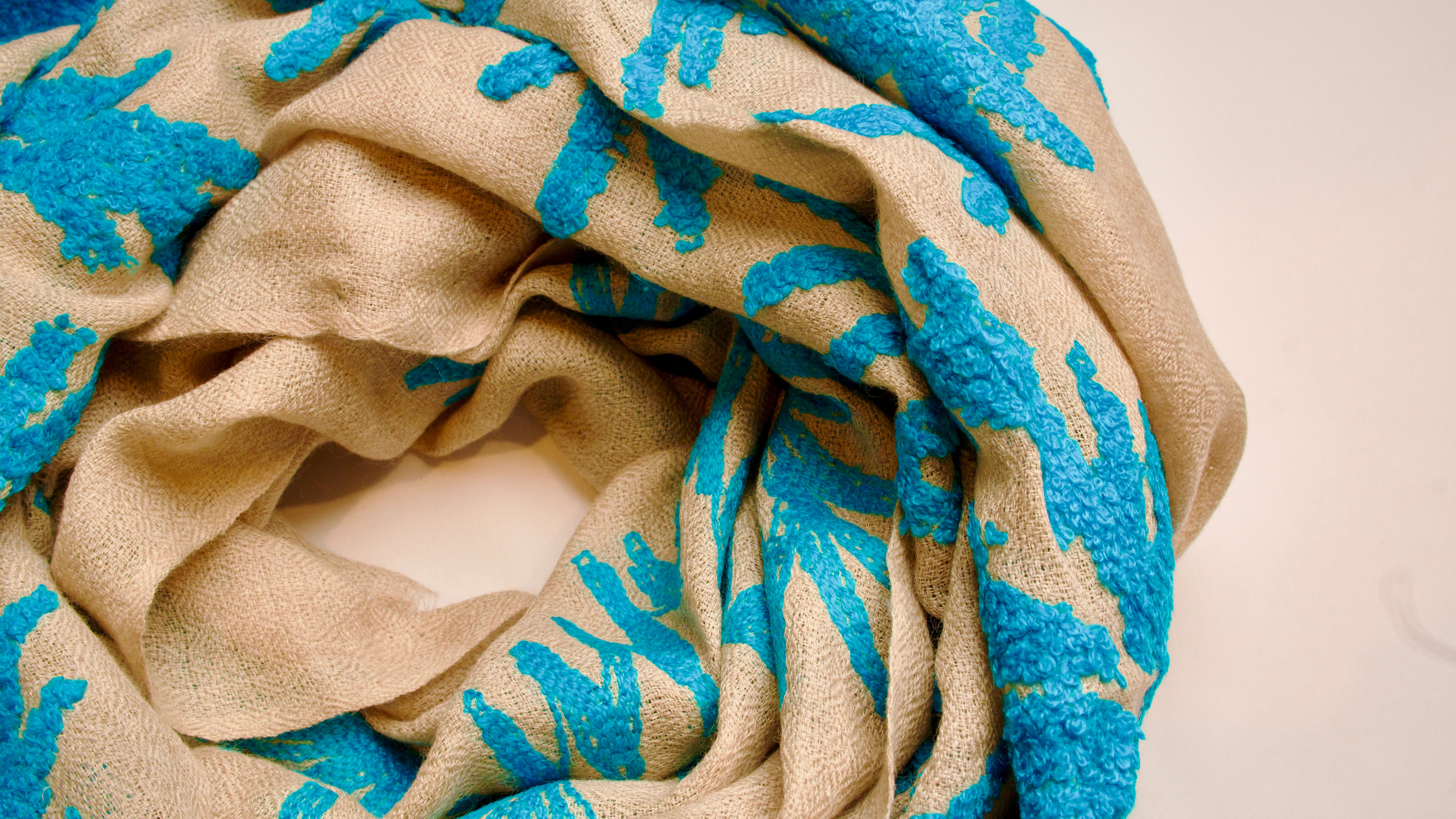 Close-up of a beige fabric with blue floral patterns