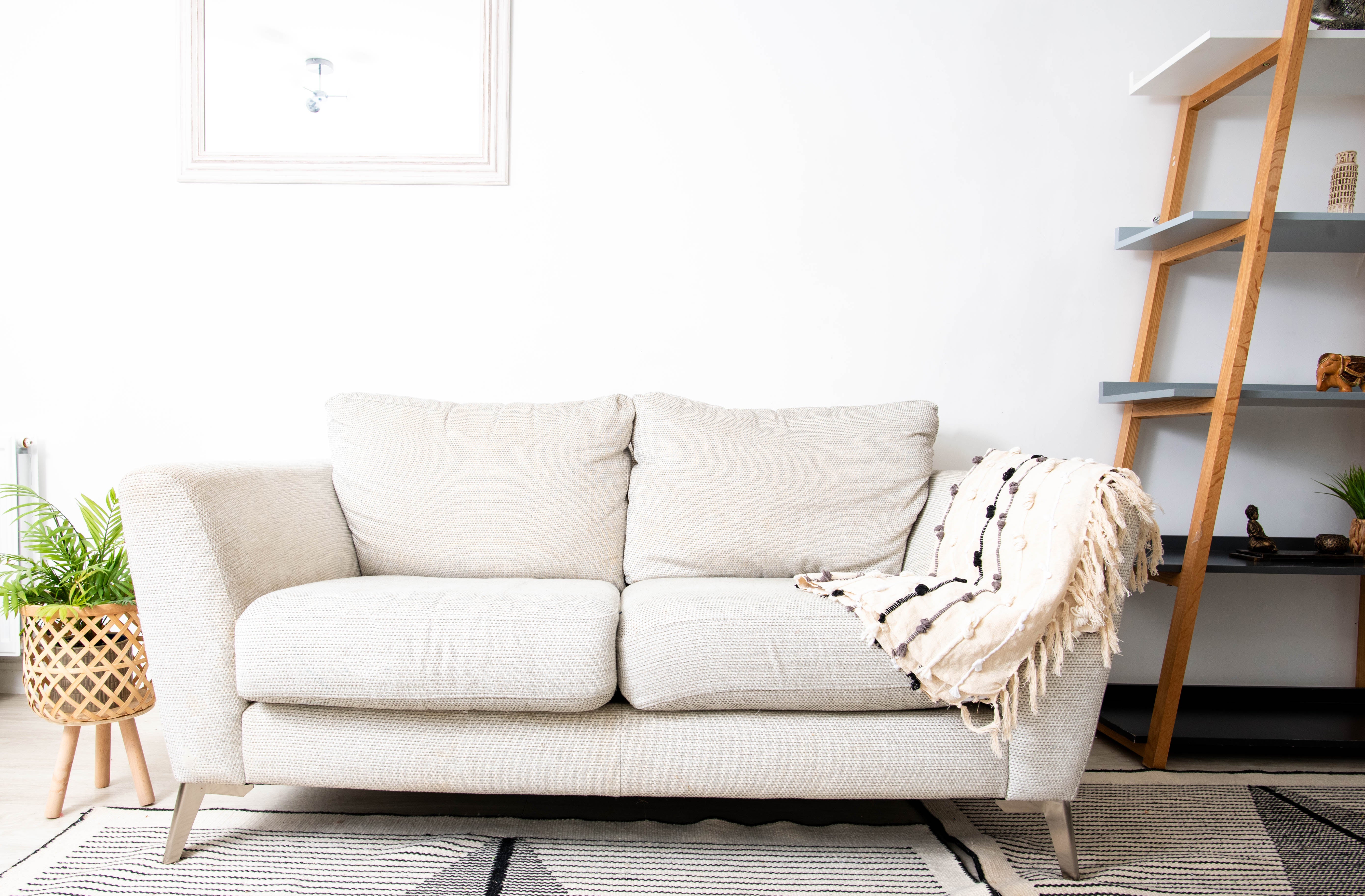 Neutral-toned sofa with pillows and blanket