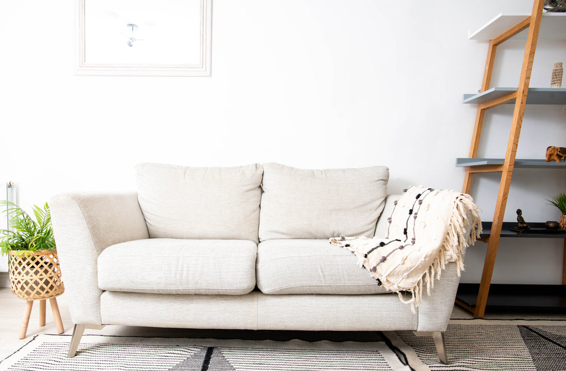 Neutral-toned sofa with pillows and blanket
