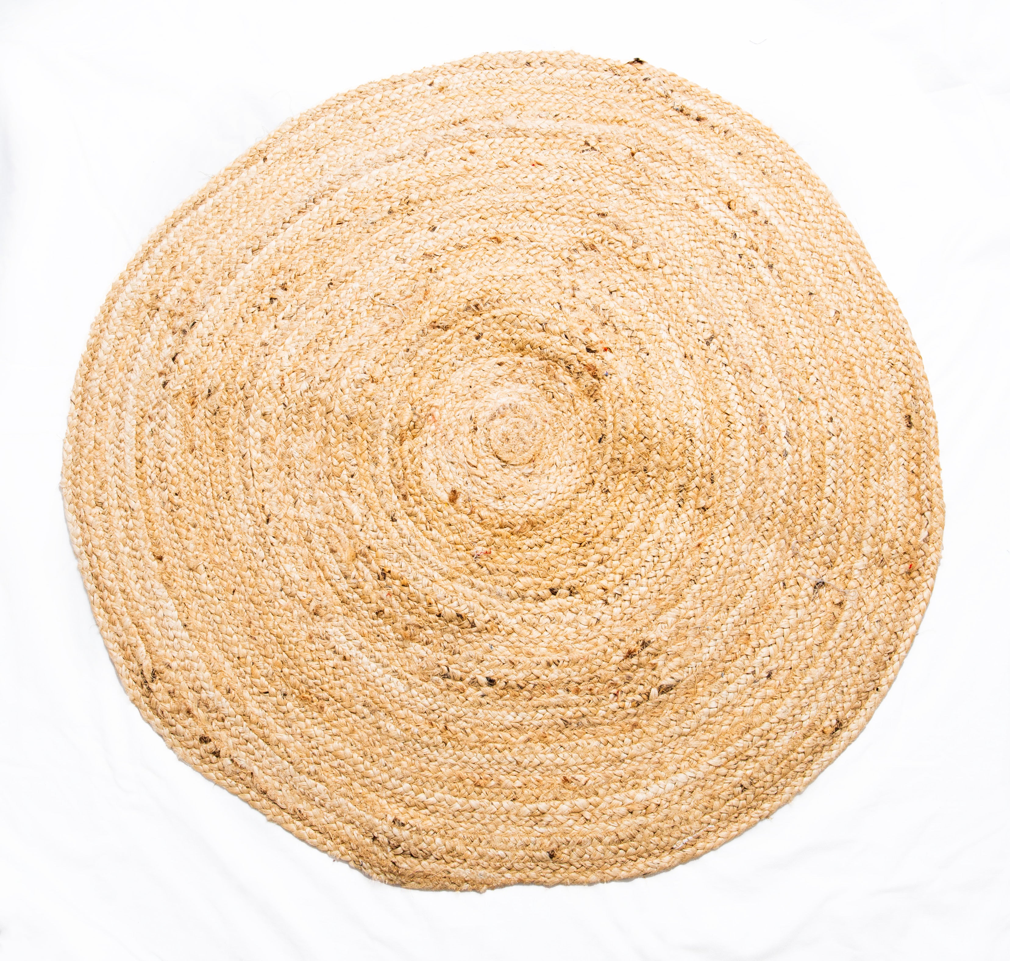 A traditional round braided jute rug with a plain design, handwoven and made from natural jute fibers.