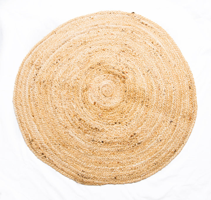 A traditional round braided jute rug with a plain design, handwoven and made from natural jute fibers.