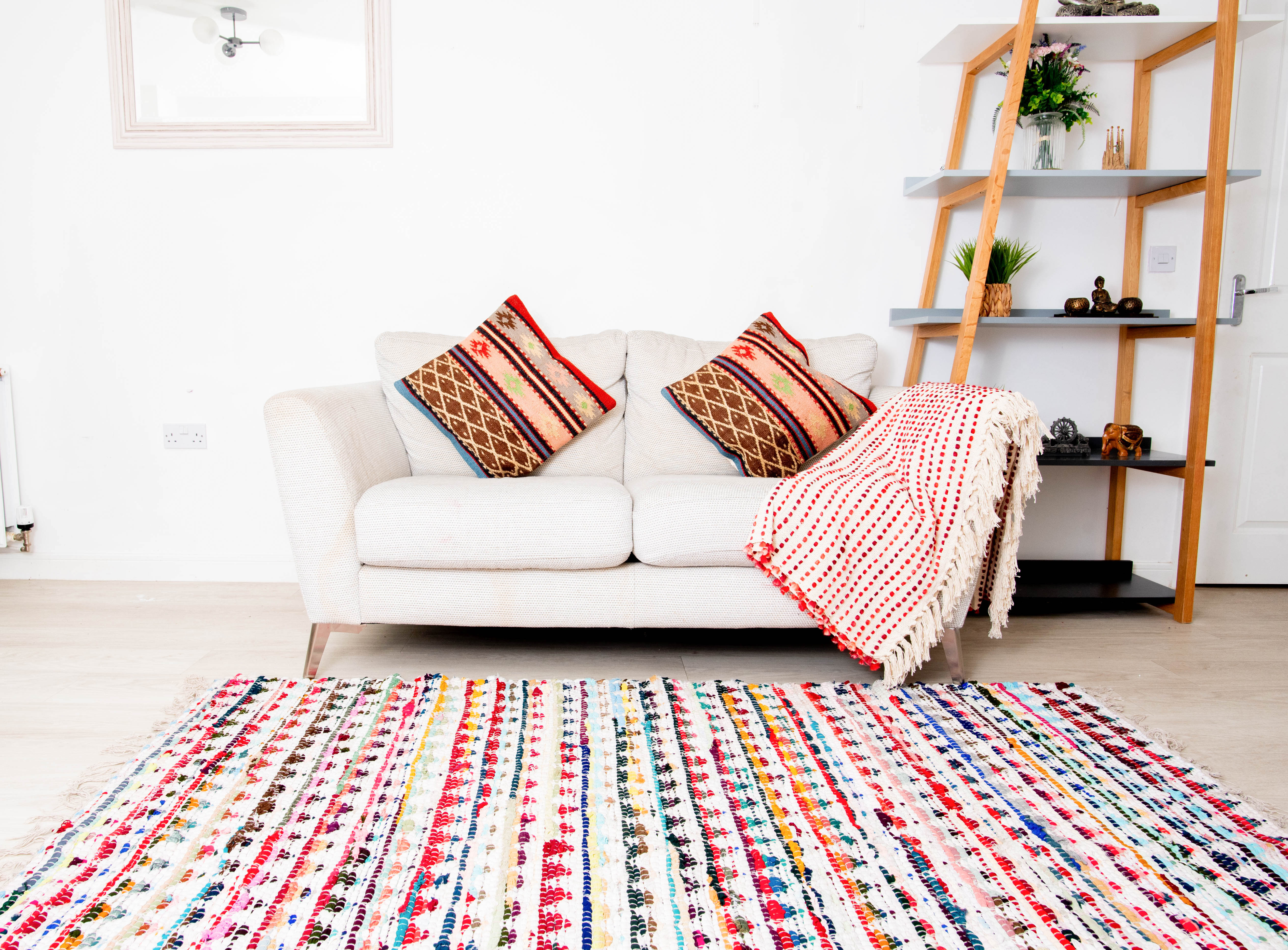 This item is a multicolor handwoven chindi rag rug often crafted from recycled cotton materials. 