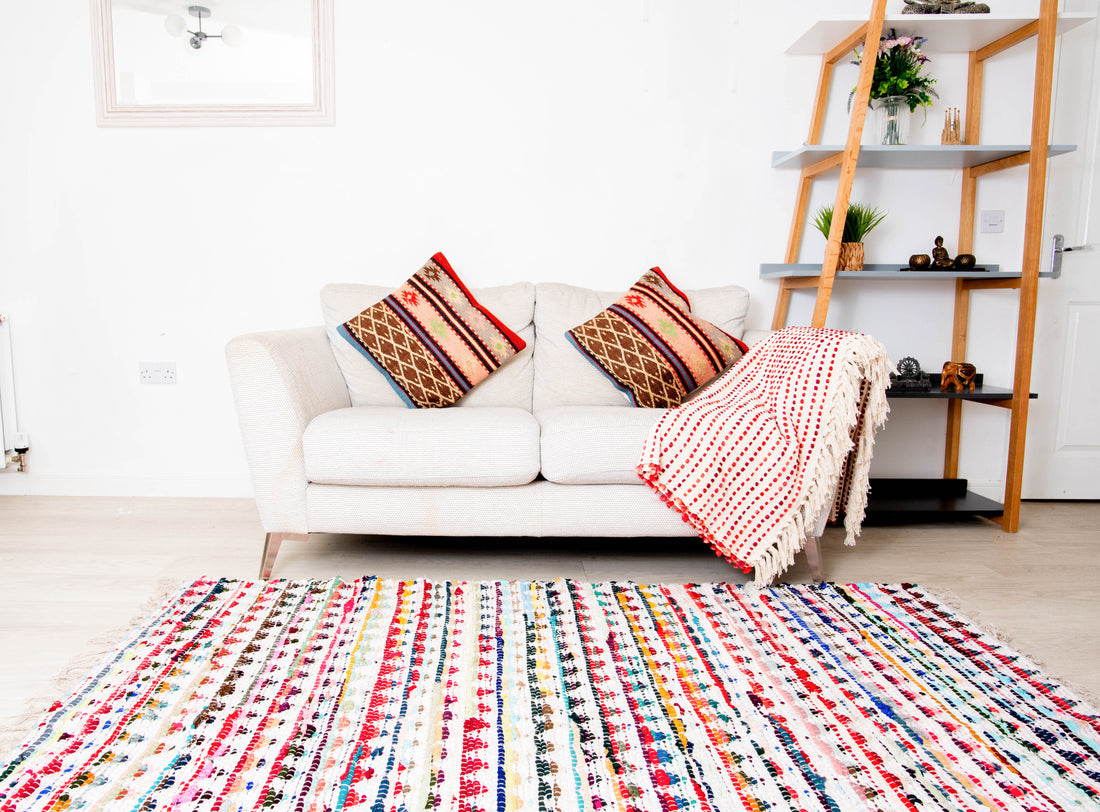 This item is a multicolor handwoven chindi rag rug often crafted from recycled cotton materials. 