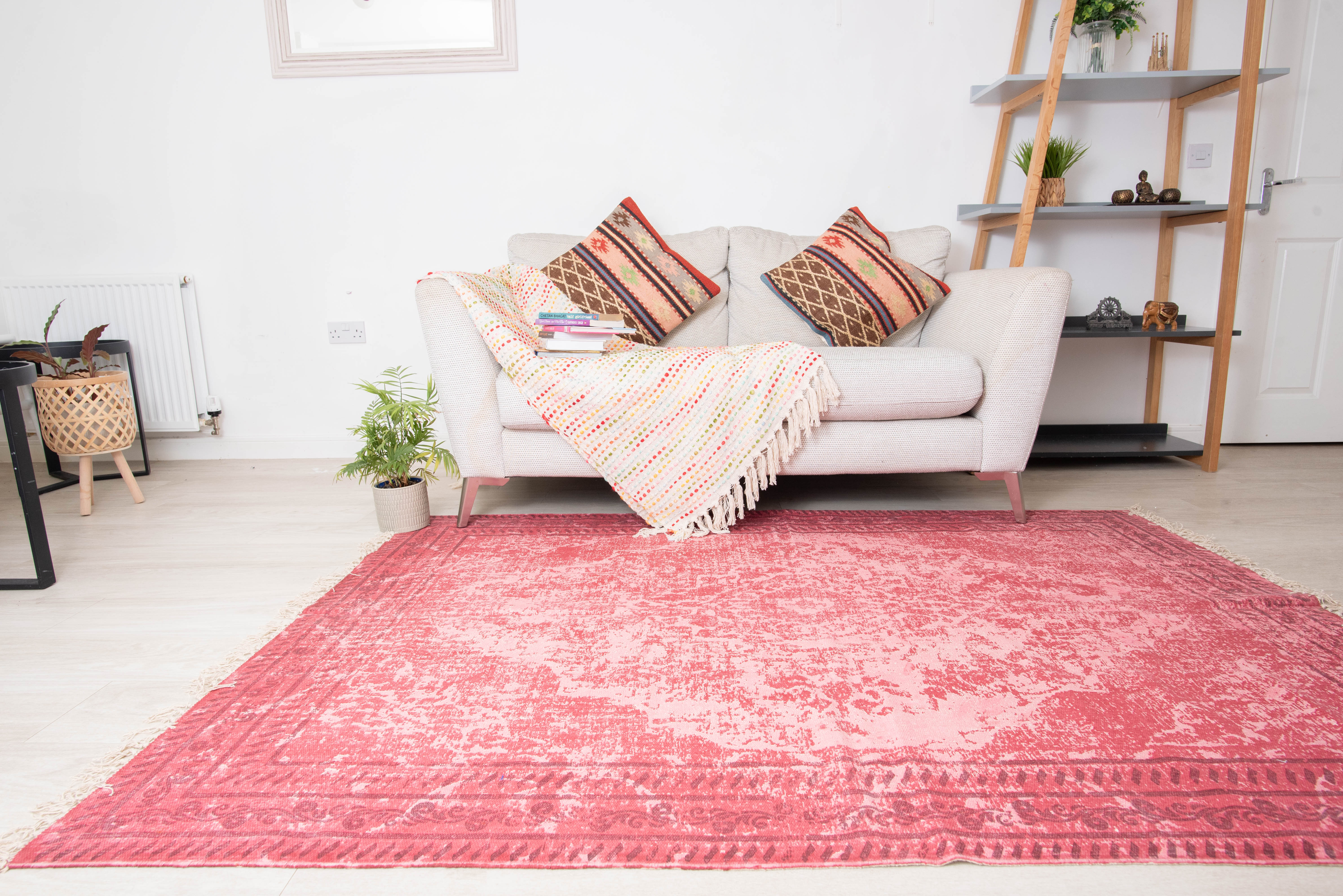 This is a Divine Handicrafts rectangular cotton rug featuring a pink, distressed medallion pattern. 