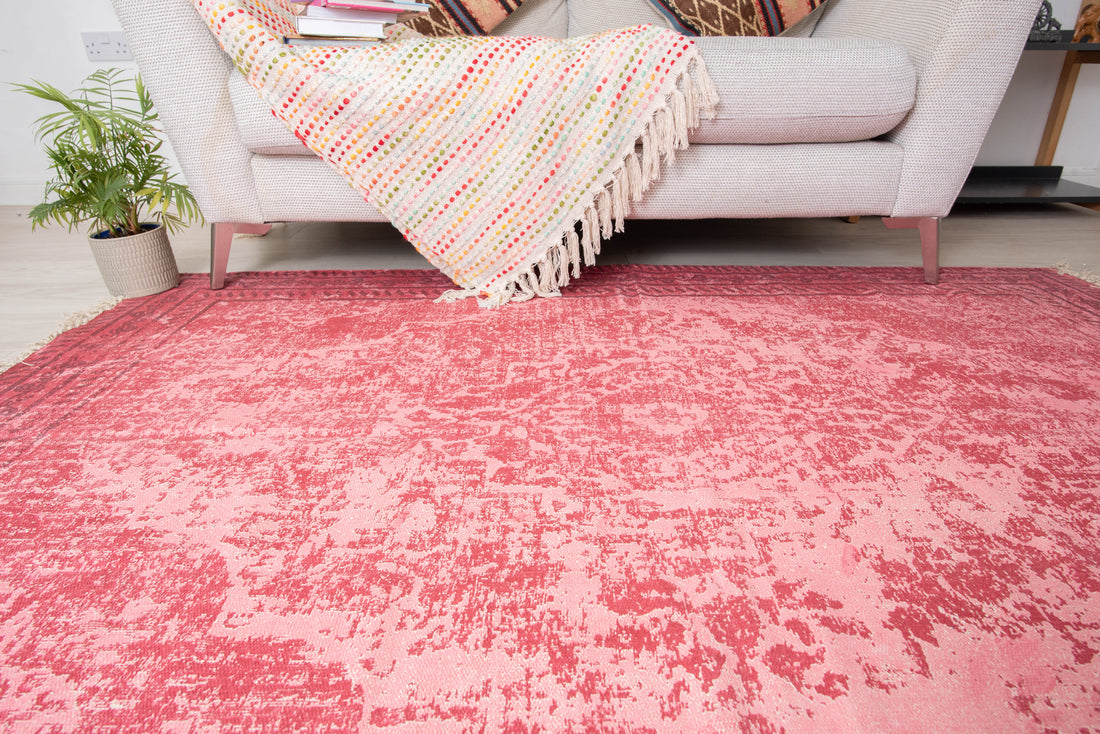 This item is a pink and white traditional printed area rug, likely matching styles from brands like Kaleen India or MUJOO, designed with a distressed vintage pattern. 