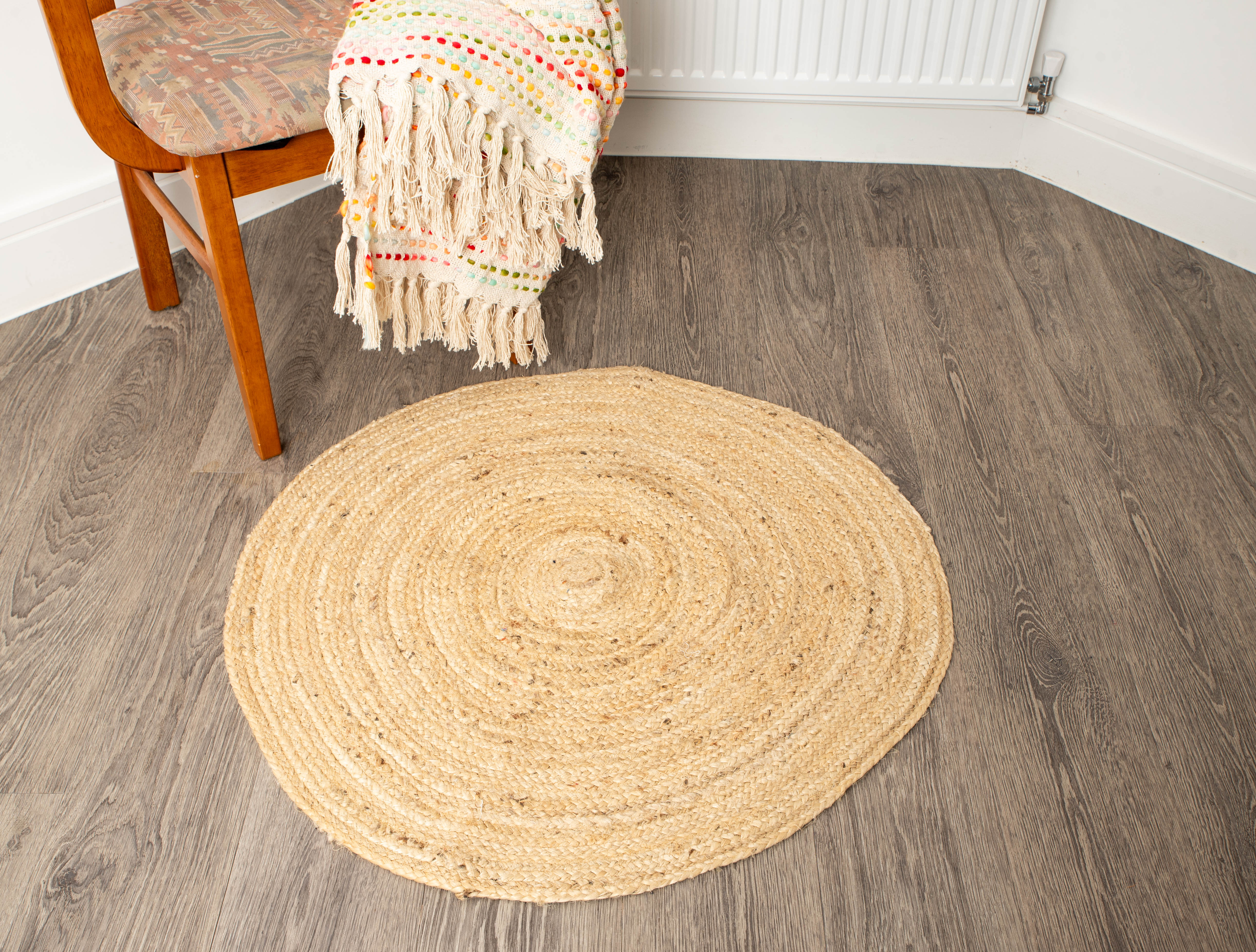 Handmade jute rug beside wooden chair and radiator