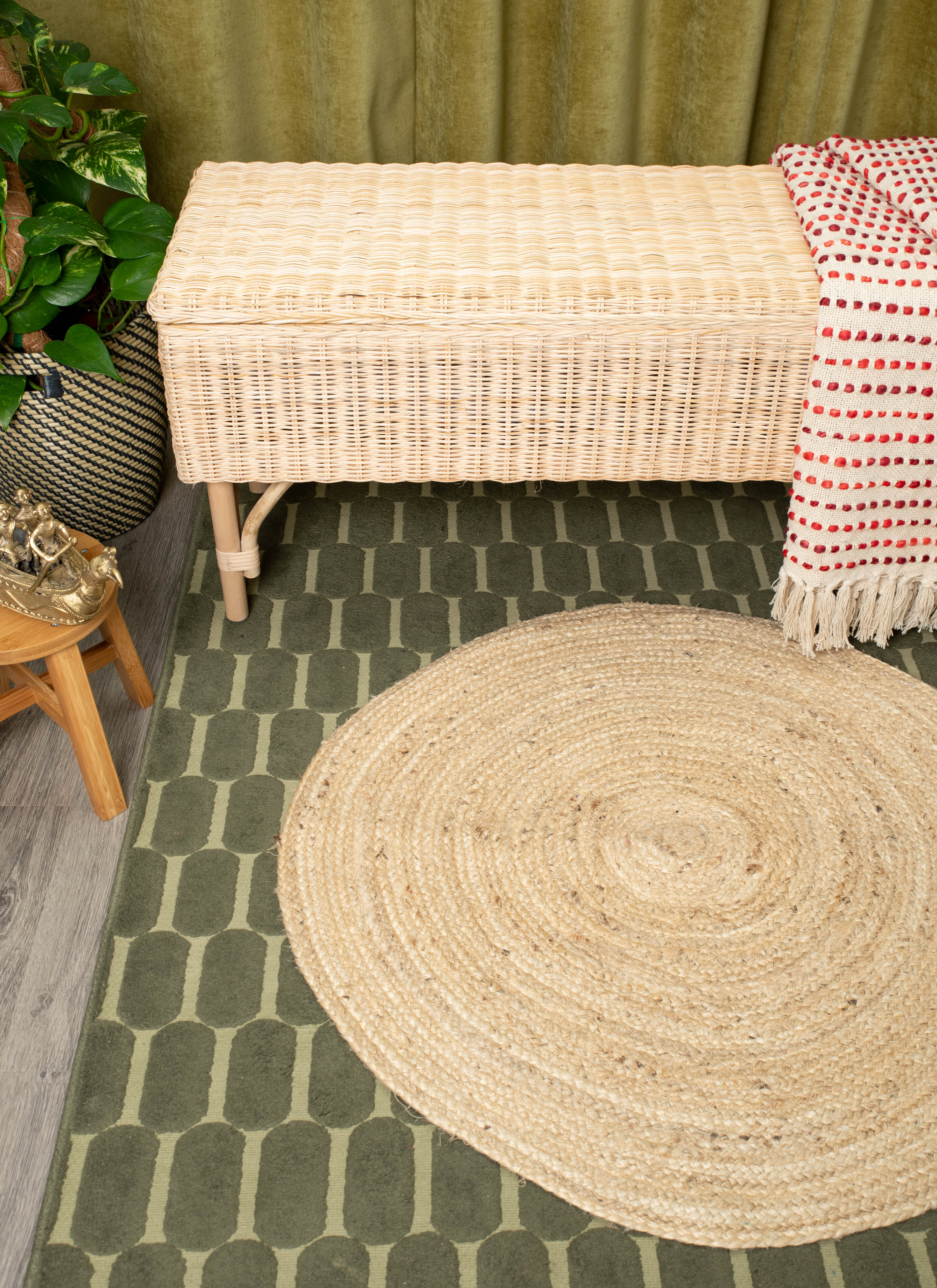 Handwoven wicker bench with lid, draped textile, and earthy home décor accents