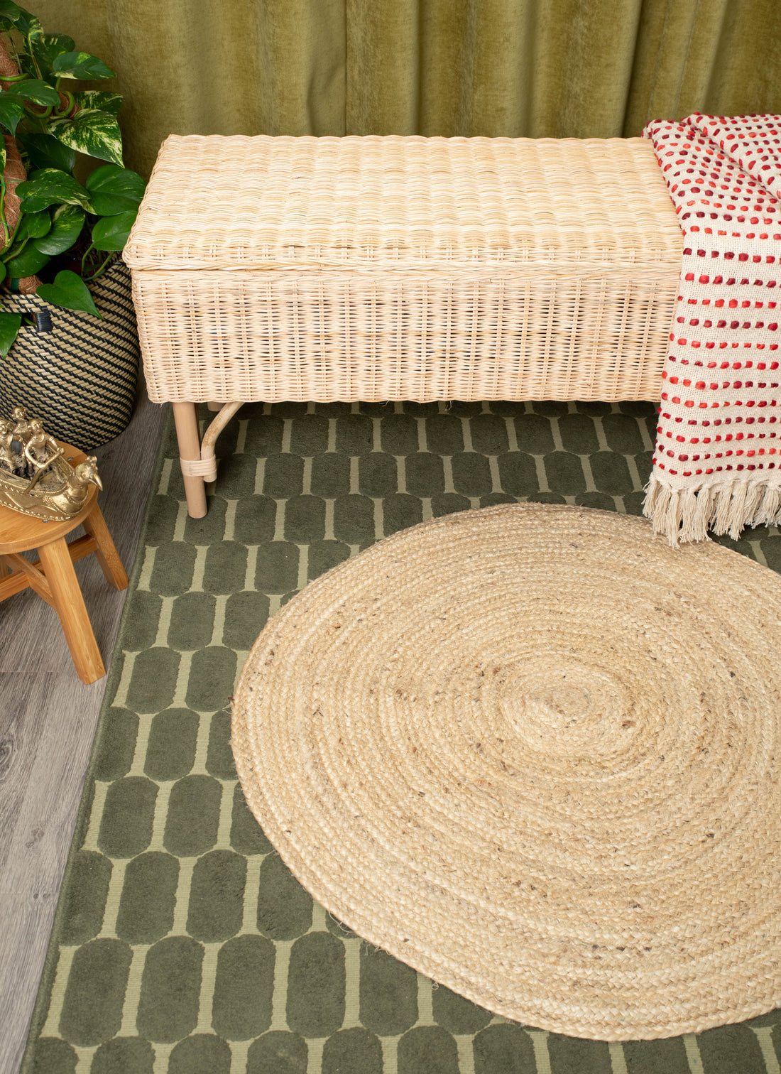 Handwoven wicker bench with lid, draped textile, and earthy home décor accents
