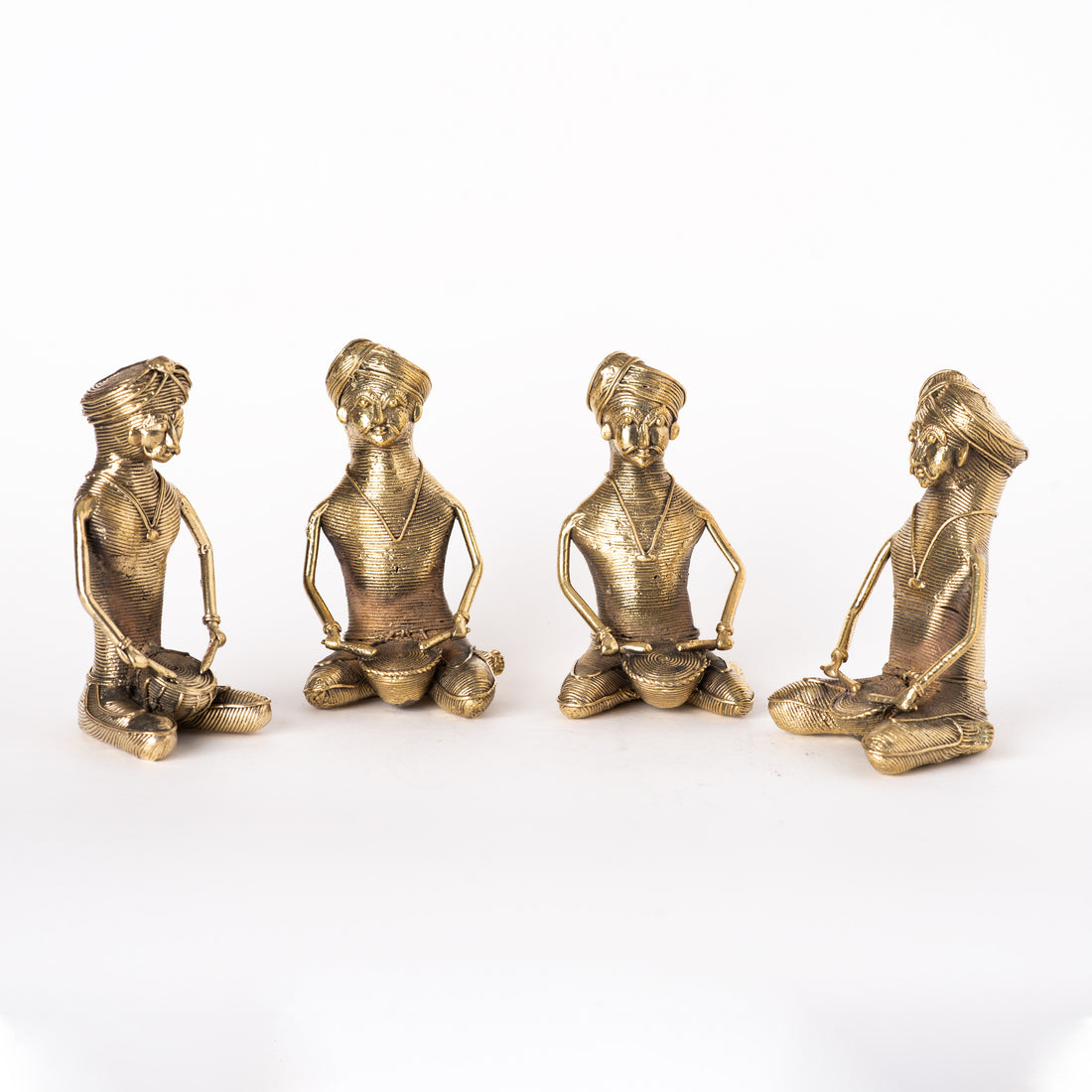 This image features a set of handmade Indian Dhokra metal musician statues, crafted using the ancient lost-wax casting technique. 
