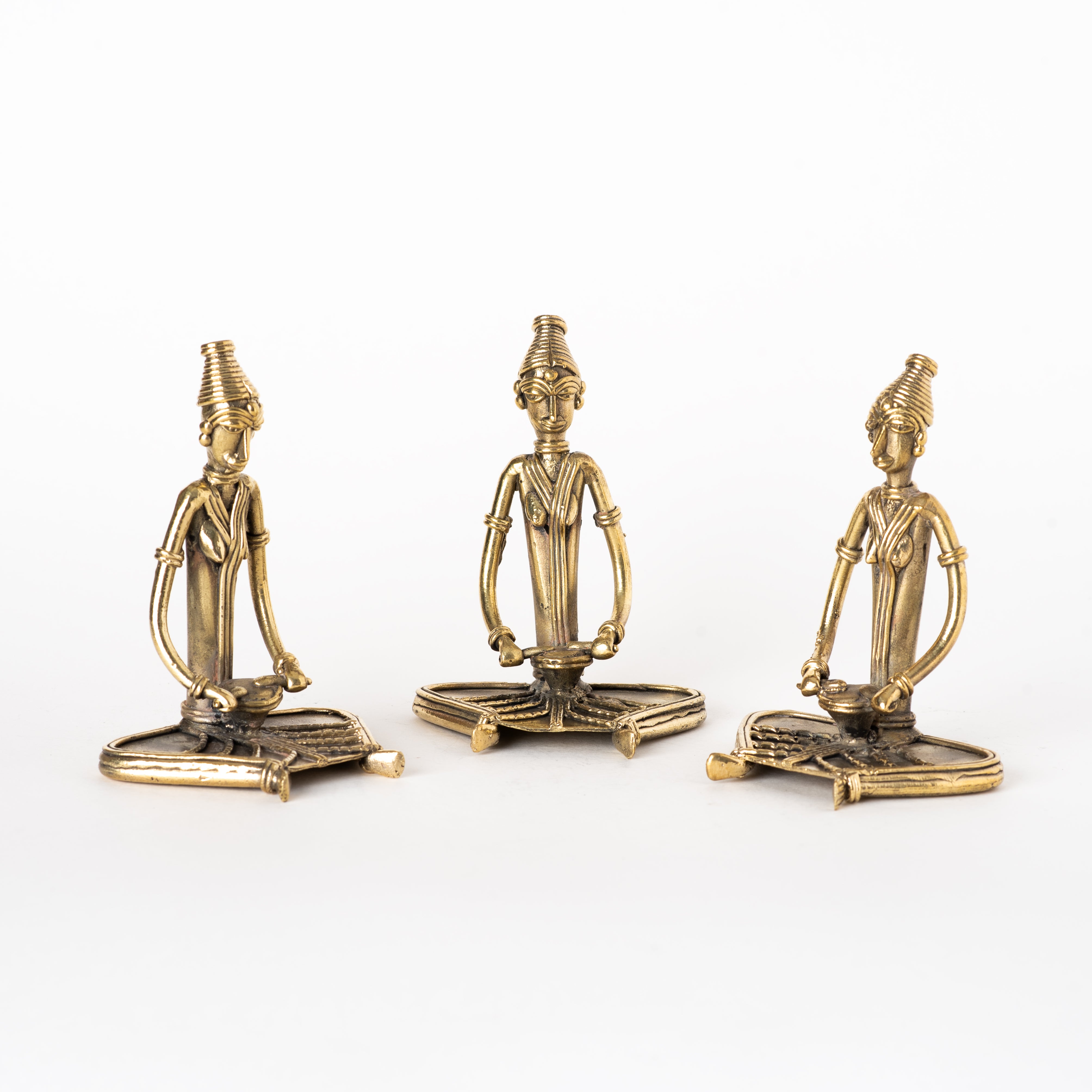 This set of three brass figurines represents the traditional Indian Dhokra (or Dokra) art form.