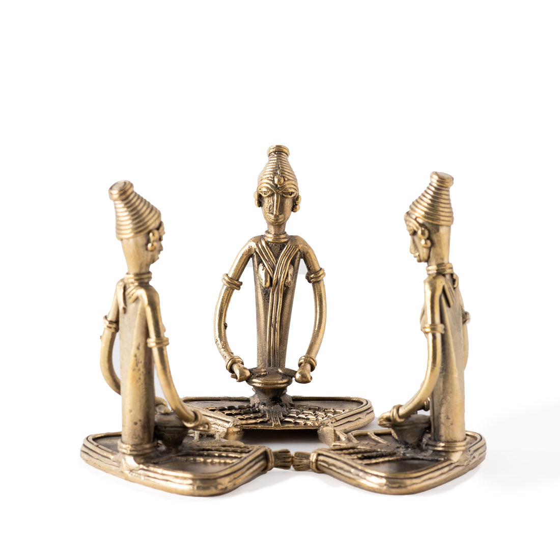 Three brass metal sculptures of sitting women 