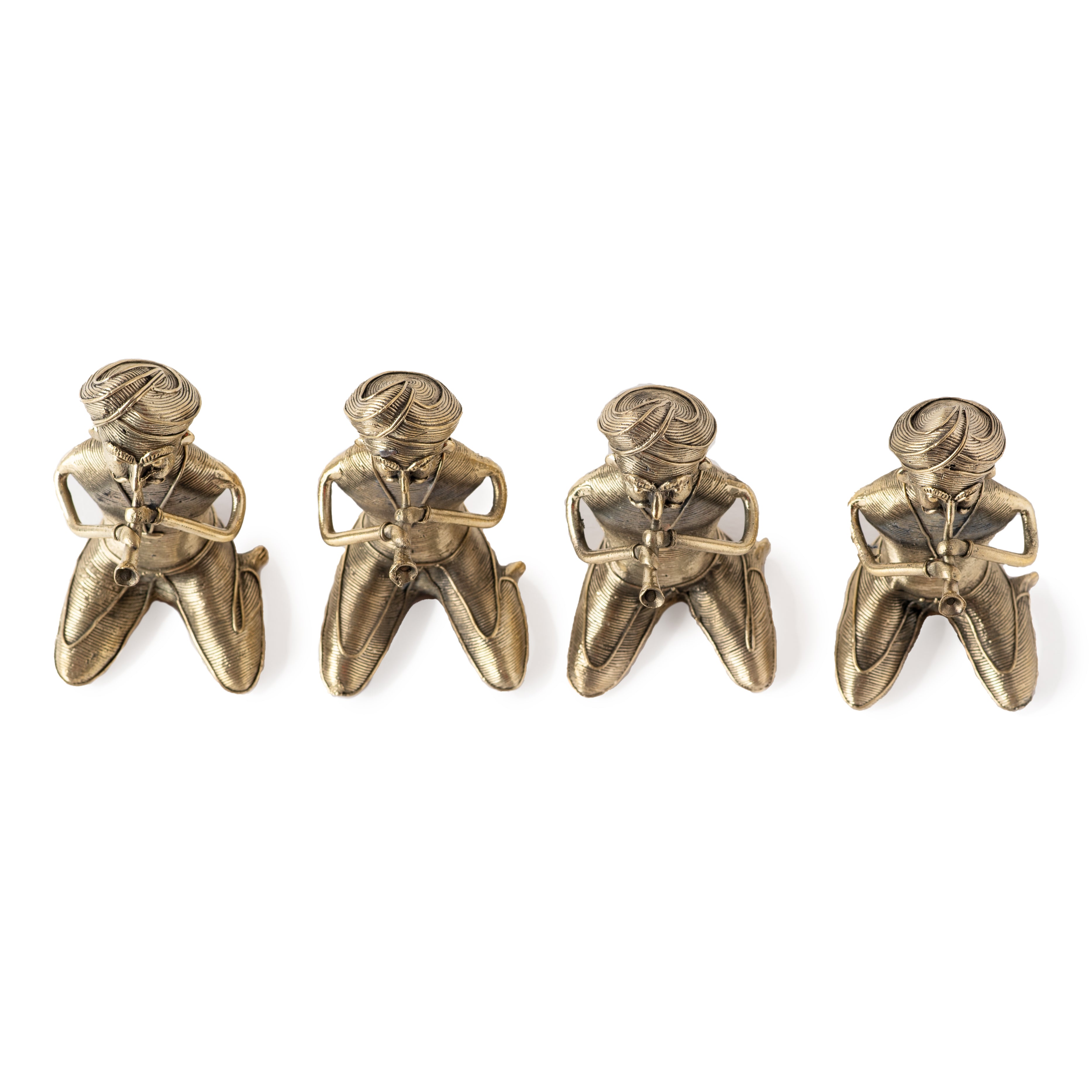 Four brass metal sculptures of sitting men musicians