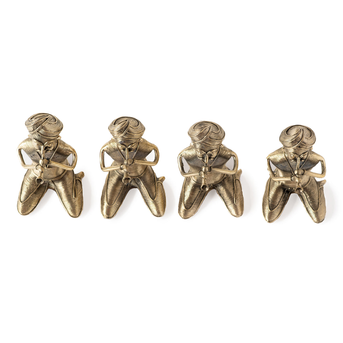 Four brass metal sculptures of sitting men musicians