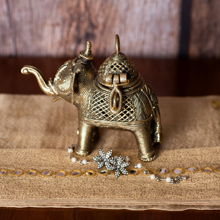 Decorative metallic elephant sculpture on fabric runner