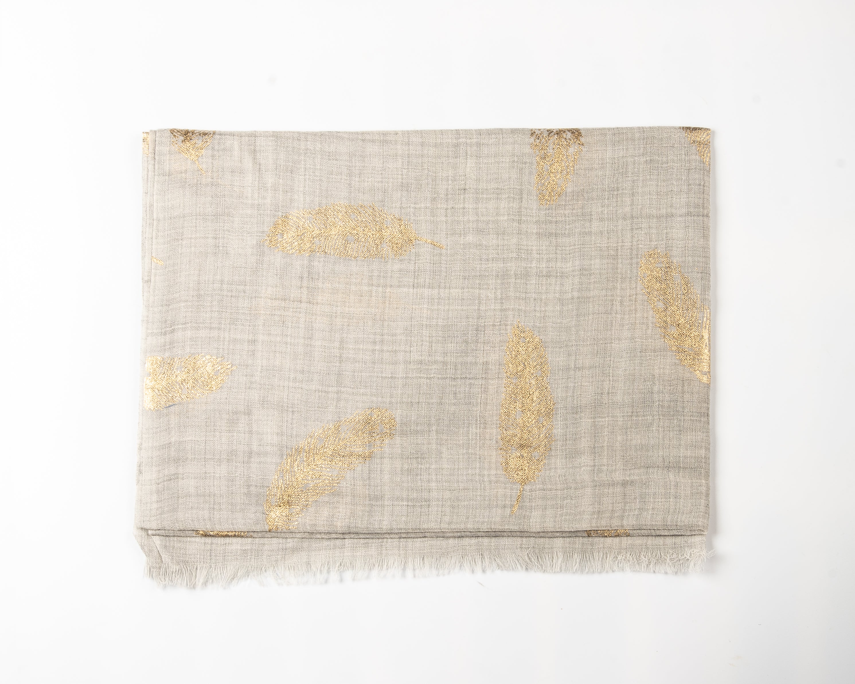 Beige linen-textured scarf with a frayed edge, featuring metallic gold feather patterns scattered across the fabric.