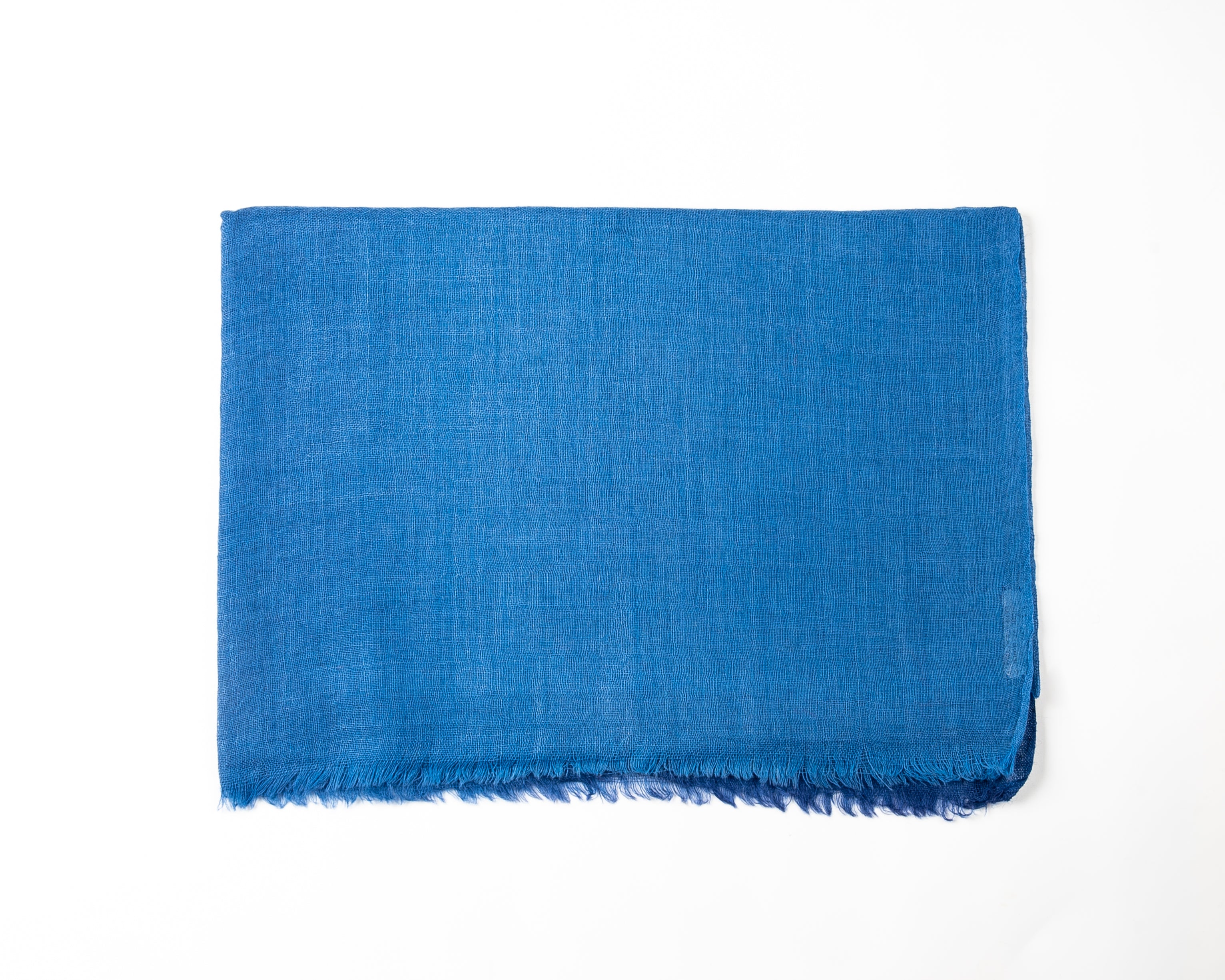 Textured blue towel with woven detail and slightly frayed edge