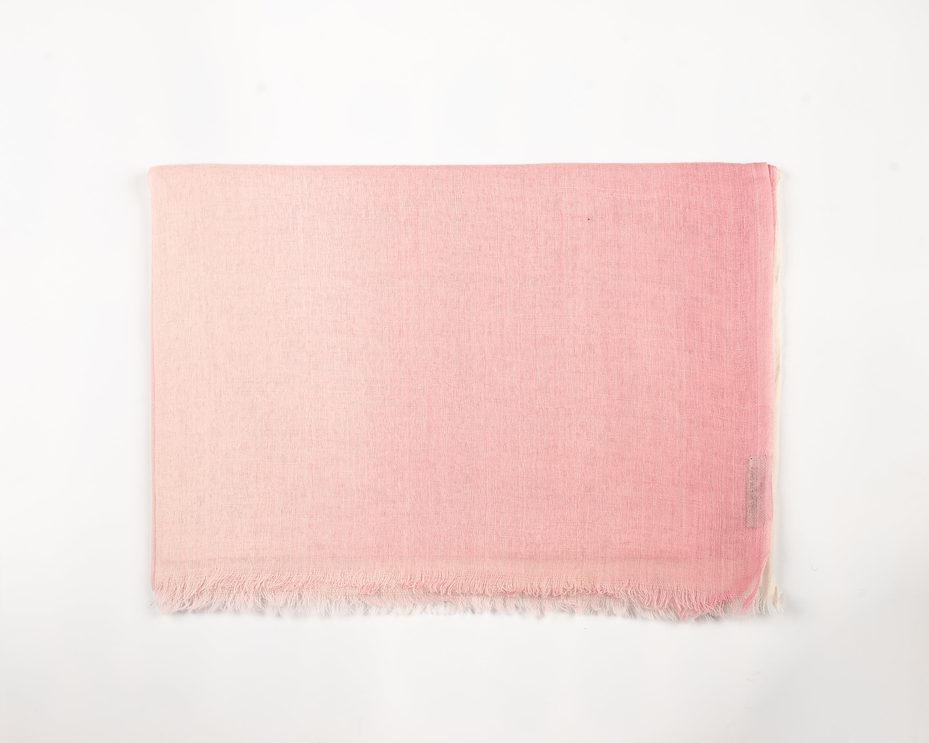 Light pink fabric swatch with subtle wavy texture and fine fringed edges
