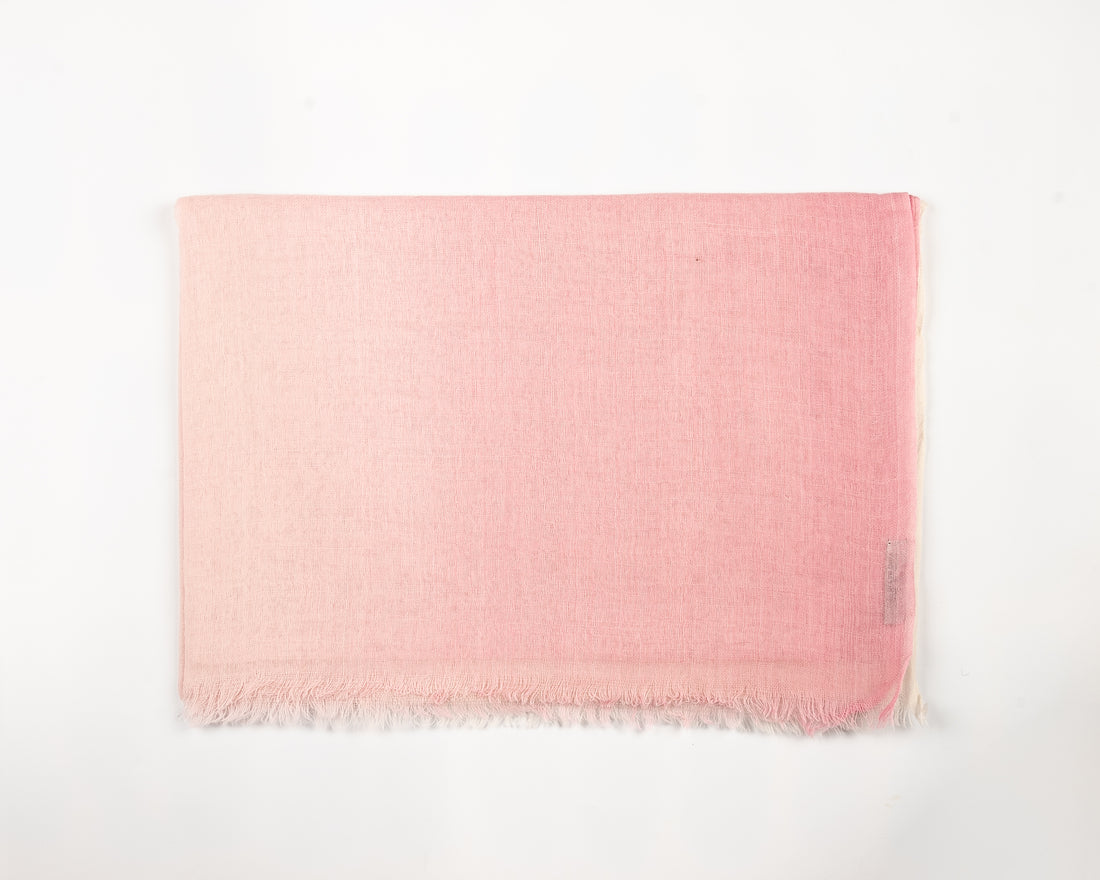 Light pink fabric swatch with subtle wavy texture and fine fringed edges

