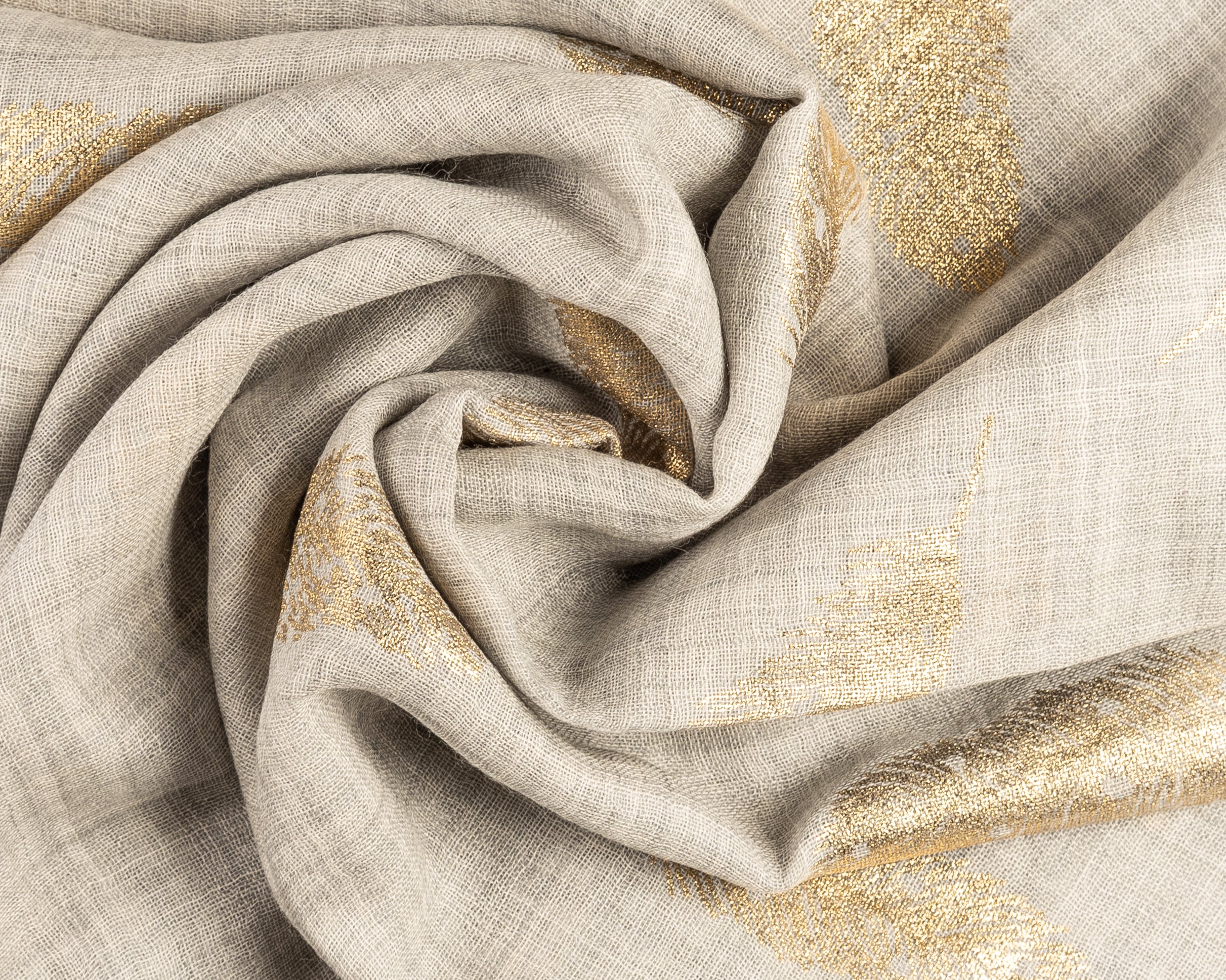 Close-up of a draped beige linen fabric with shimmering gold metallic feather patterns swirled in the center.