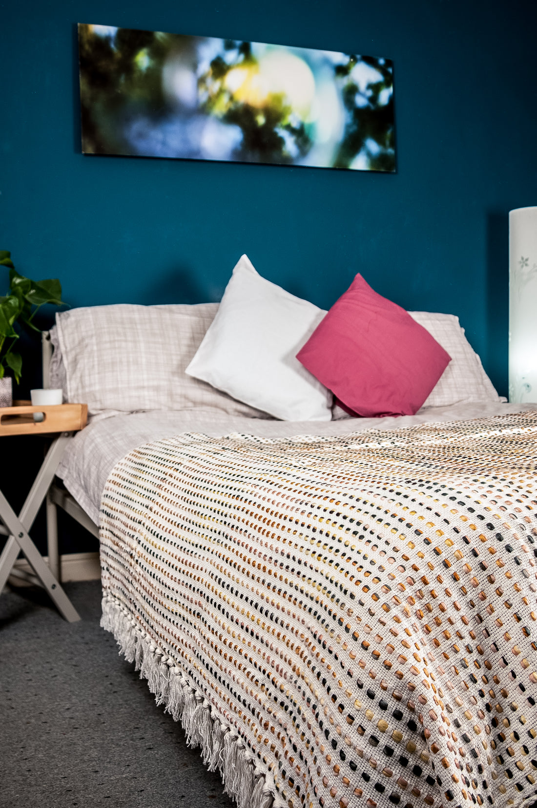 Cozy bedroom with checkered bedspread and knitted blanket