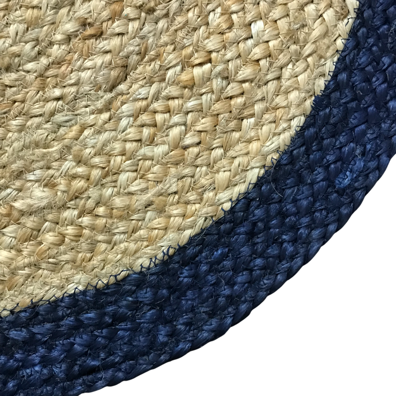 Close-up of a woven mat with natural beige center and navy blue border