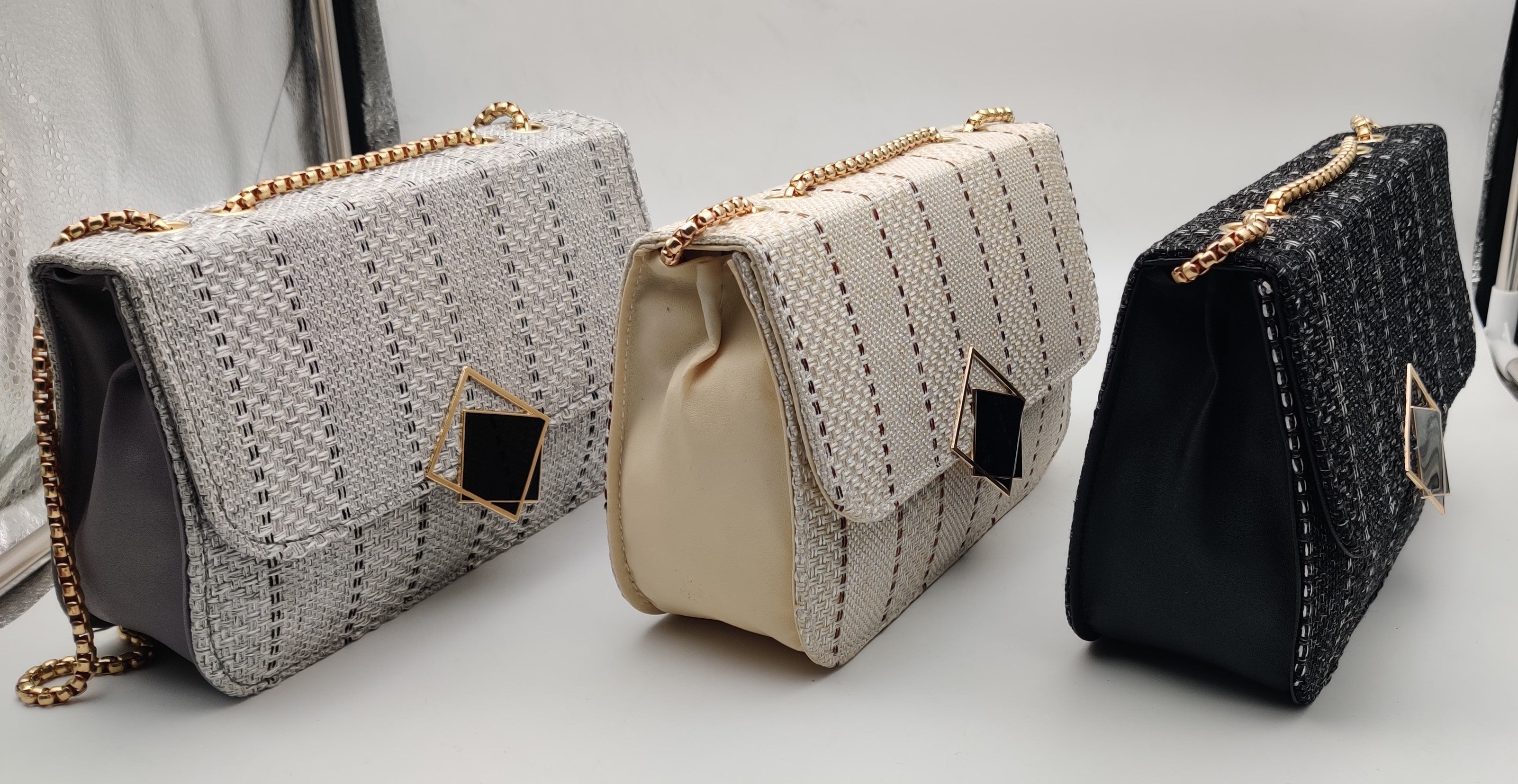 A distinctive geometric textured fabric, a black square accent handbag