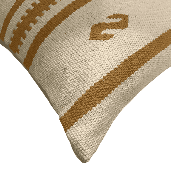 Close-up of a textured pillow with brown patterns on a beige background