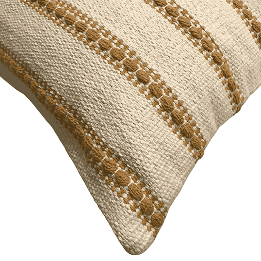 Close-up of a textured pillow with brown embroidery on a white background