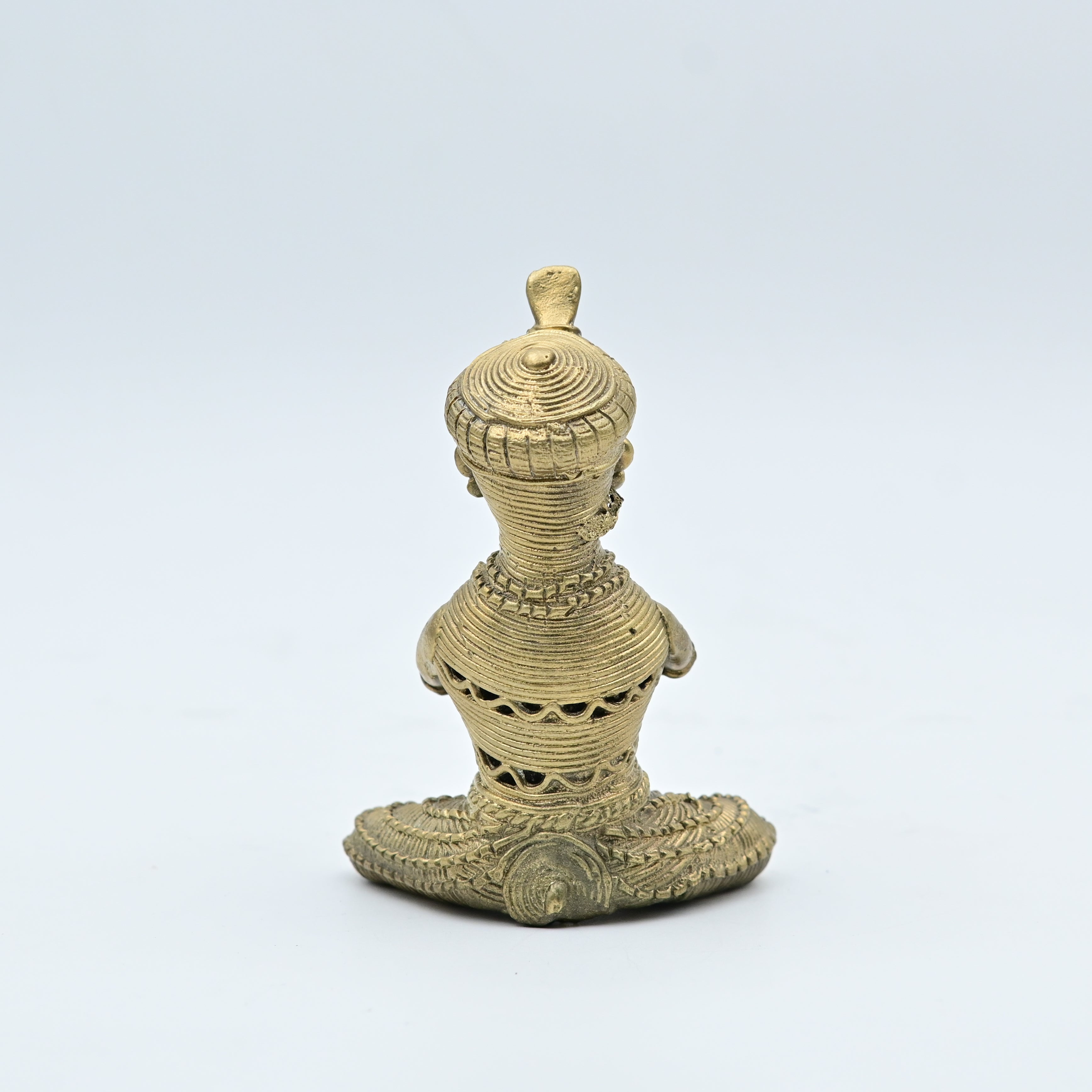 This item is a traditional Dhokra brass figurine, a form of tribal art from India created using the ancient lost-wax casting technique. 