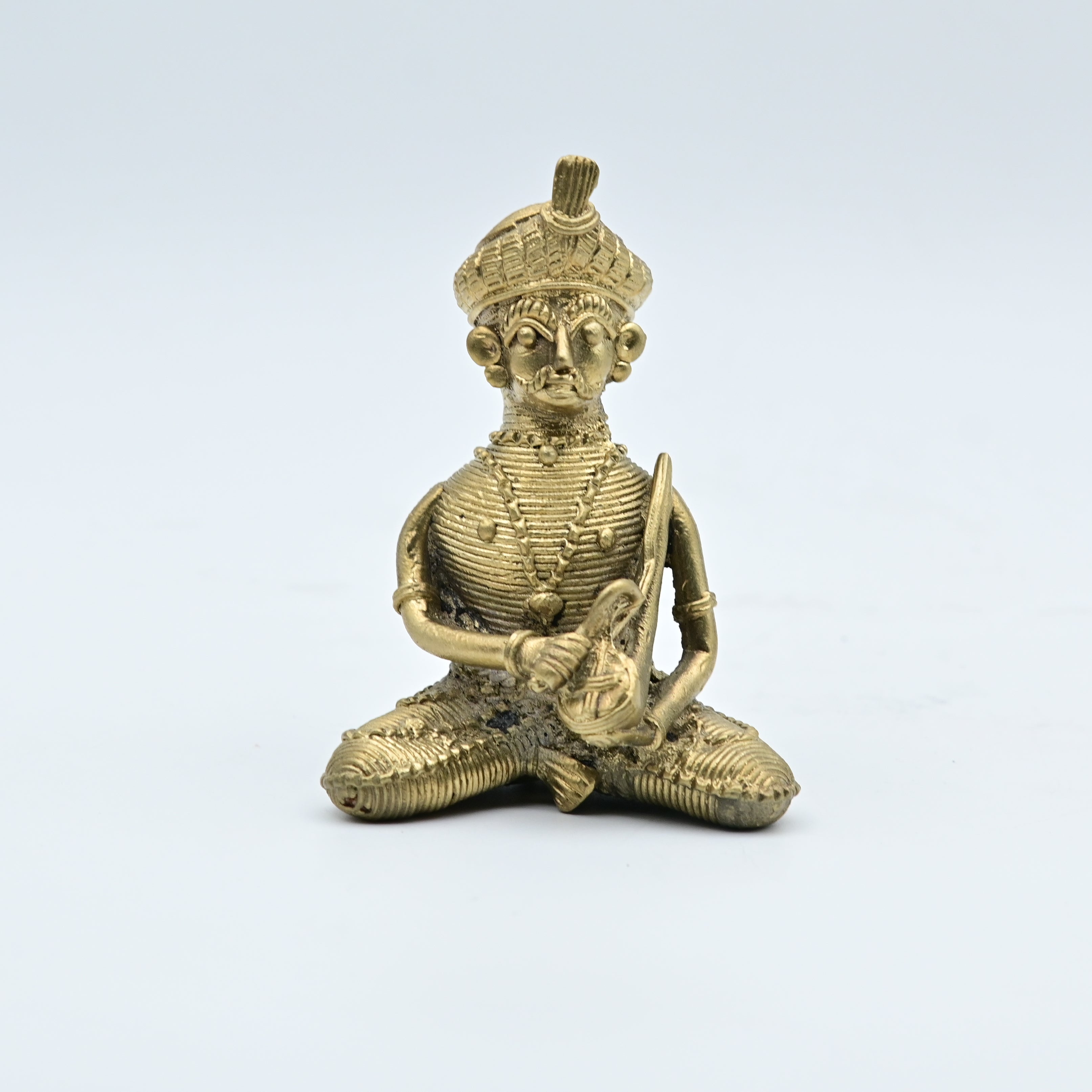 This item is a traditional Dhokra brass figurine, a form of tribal art from India created using the ancient lost-wax casting technique. 