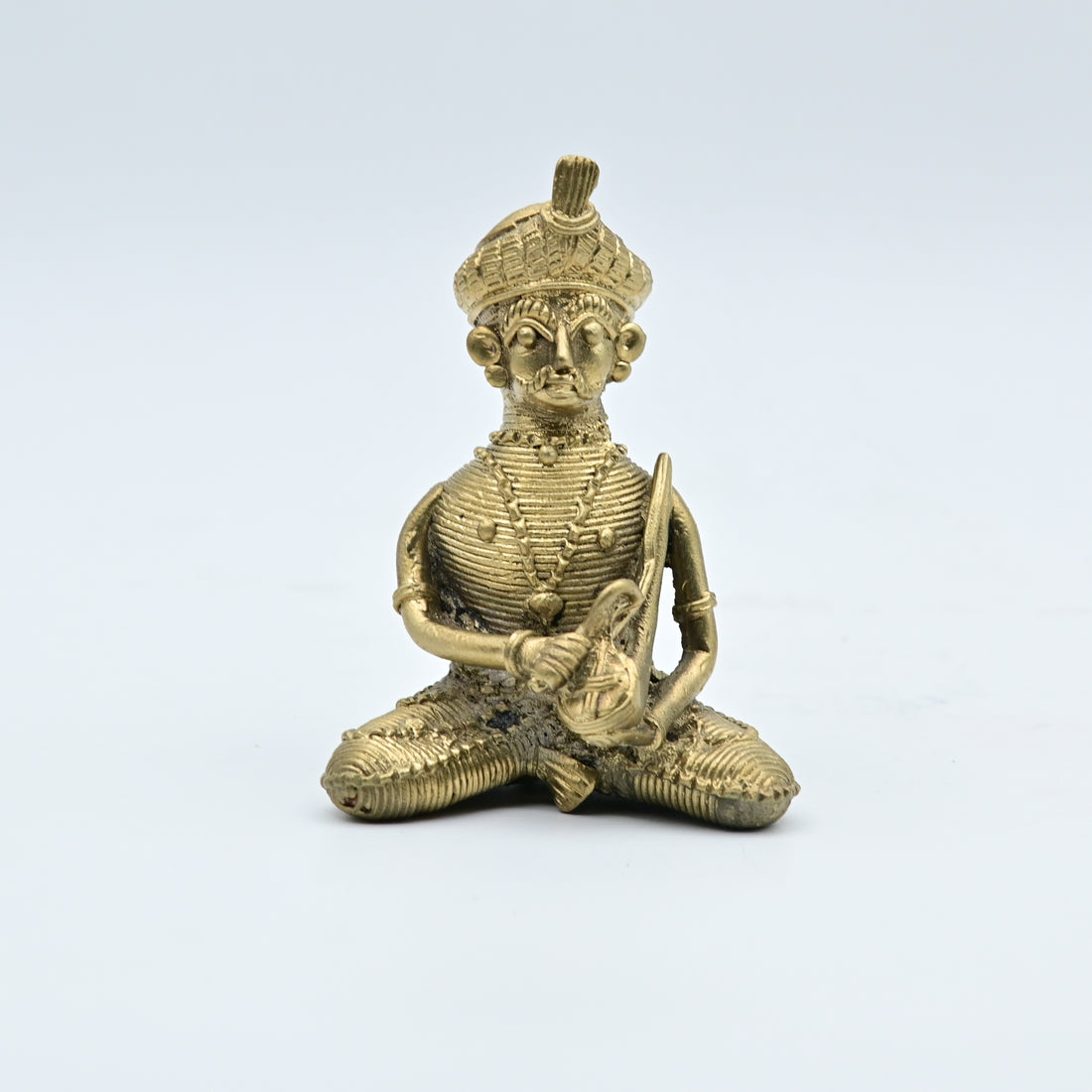 This item is a traditional Dhokra brass figurine, a form of tribal art from India created using the ancient lost-wax casting technique. 